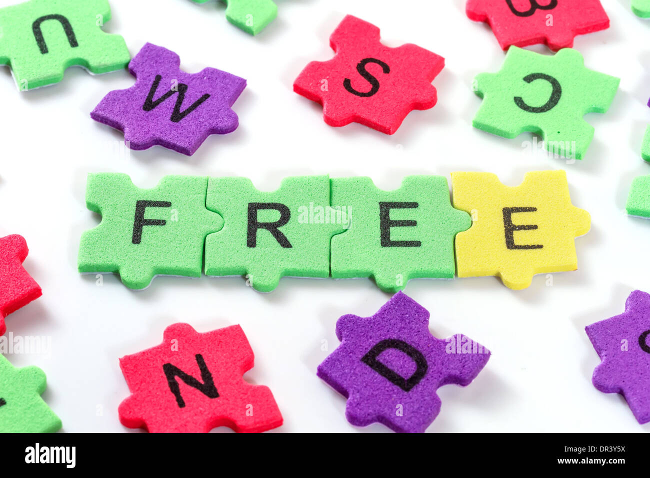 word FREE formed with colorful foam puzzle on white background Stock Photo