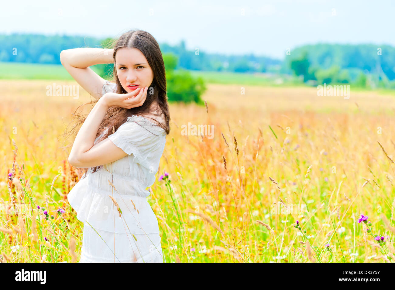 beautiful woman posing in a field of flowers Stock Photo - Alamy