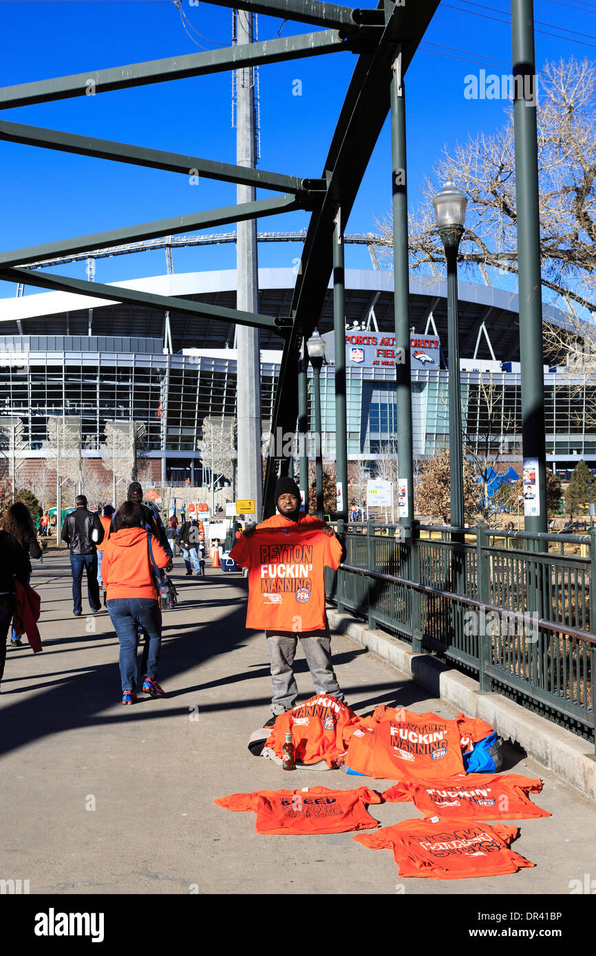 Denver, Colorado USA – 19 January 2014.  A T-Shirt Vendor sells solicits t-shirts to Football fans arriving at Sports Authority Field at Mile High before the AFC playoff game between the Denver Broncos and New England Patriots. Credit:  Ed Endicott/Alamy Live News Stock Photo