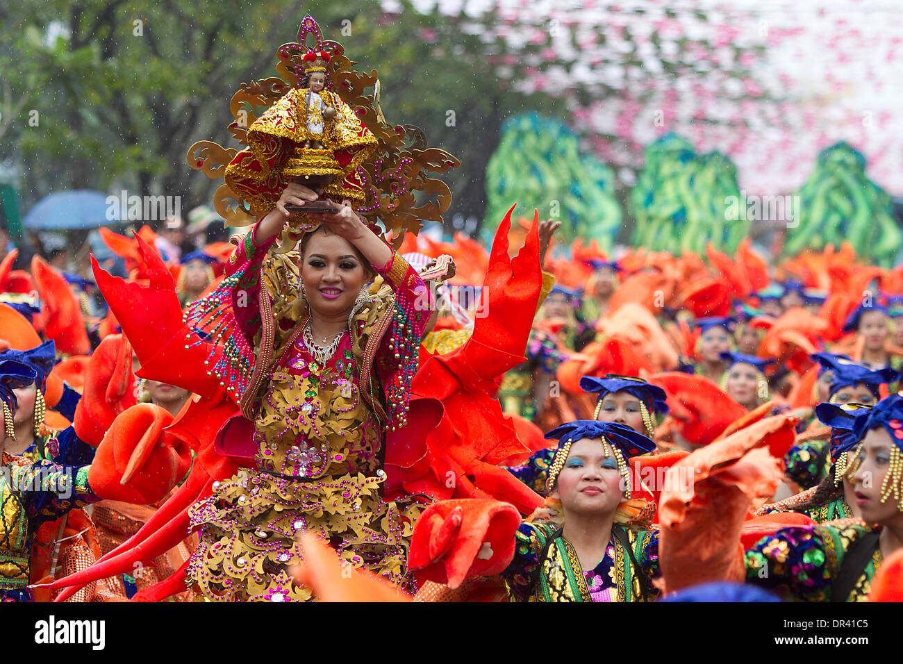 Cebu City, Philippines. 19th Jan, 2014. The nine day Catholic religious festival of Sinulog culminates on the third Sunday of January each year in one of the largest street dancing parades in the Philippines.The festival celebrates the Catholic belief of the holy Child Jesus 'Santo Nino'  Credit:  imagegallery2/Alamy Live News Stock Photo