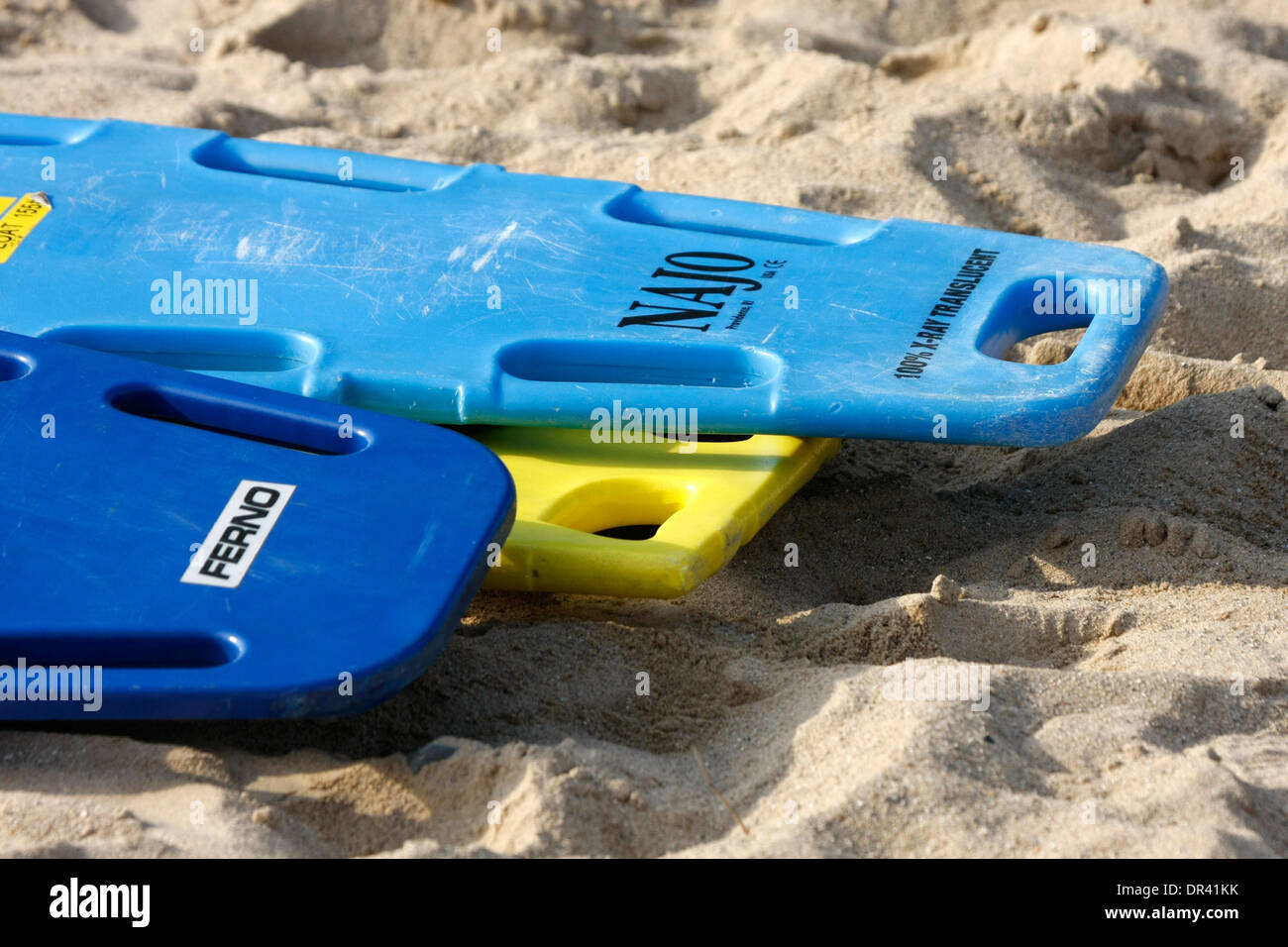 EMS medical backboards laying in the sand at a site of a mass casualty