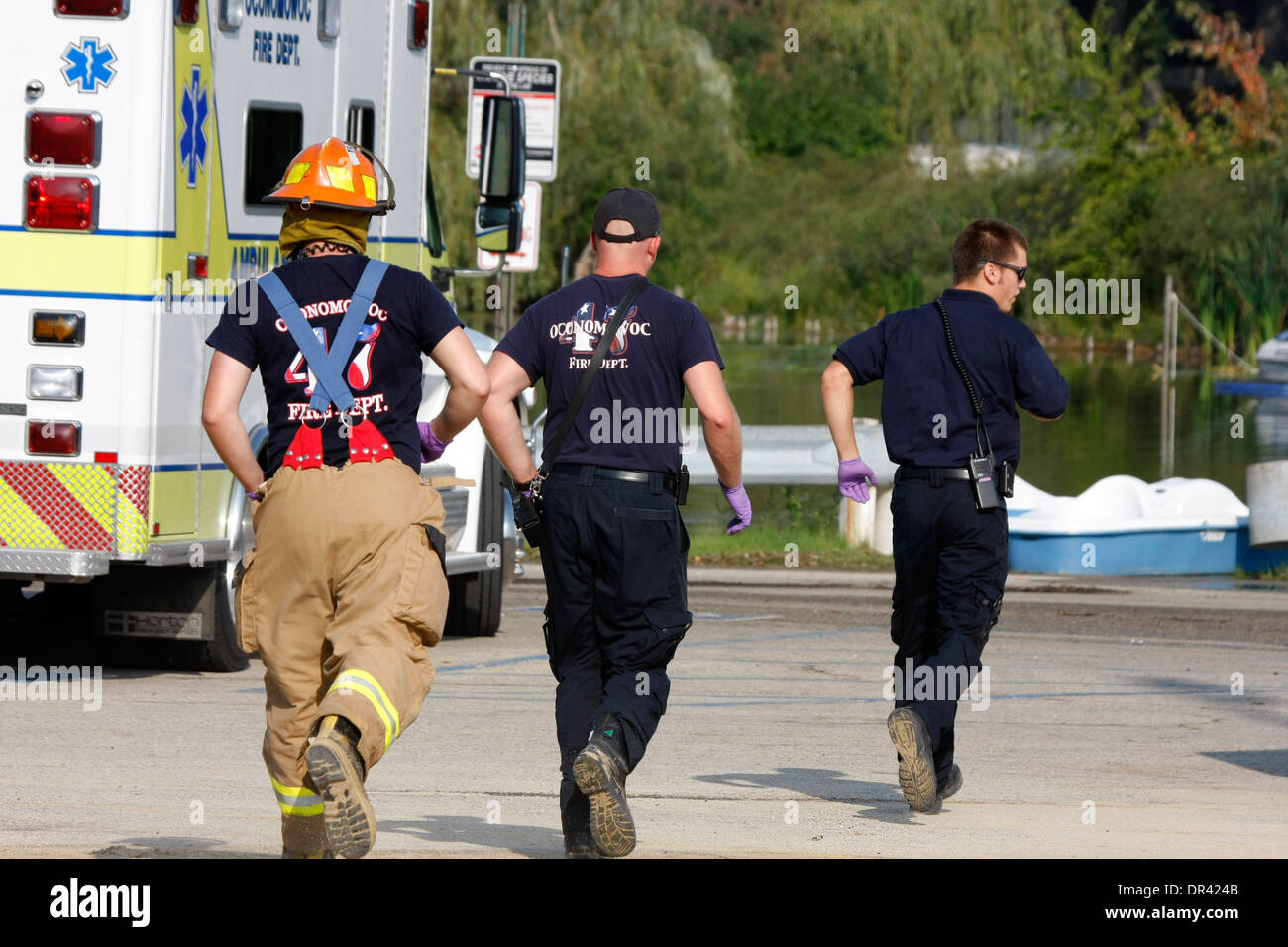 Three firefighter emts running for an emergency Stock Photo