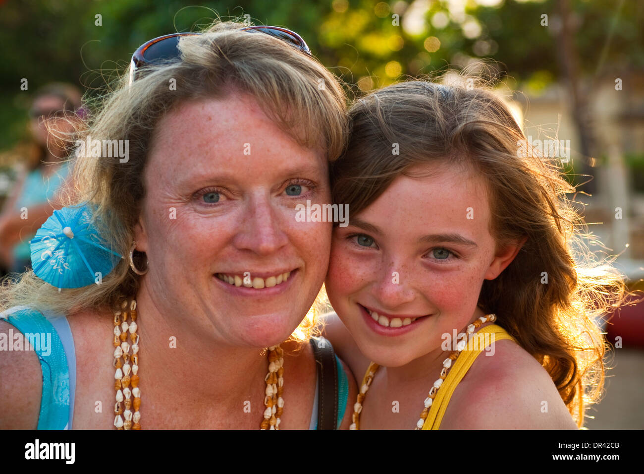 Genetic similarities in face of mother and daughter, Paradise Cove Luau, Kapolei, Oahu, Hawaii Stock Photo