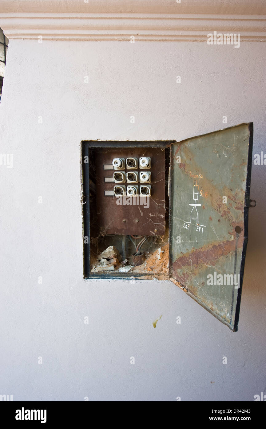A wideopen fuse box in the wall in the street Stock Photo Alamy