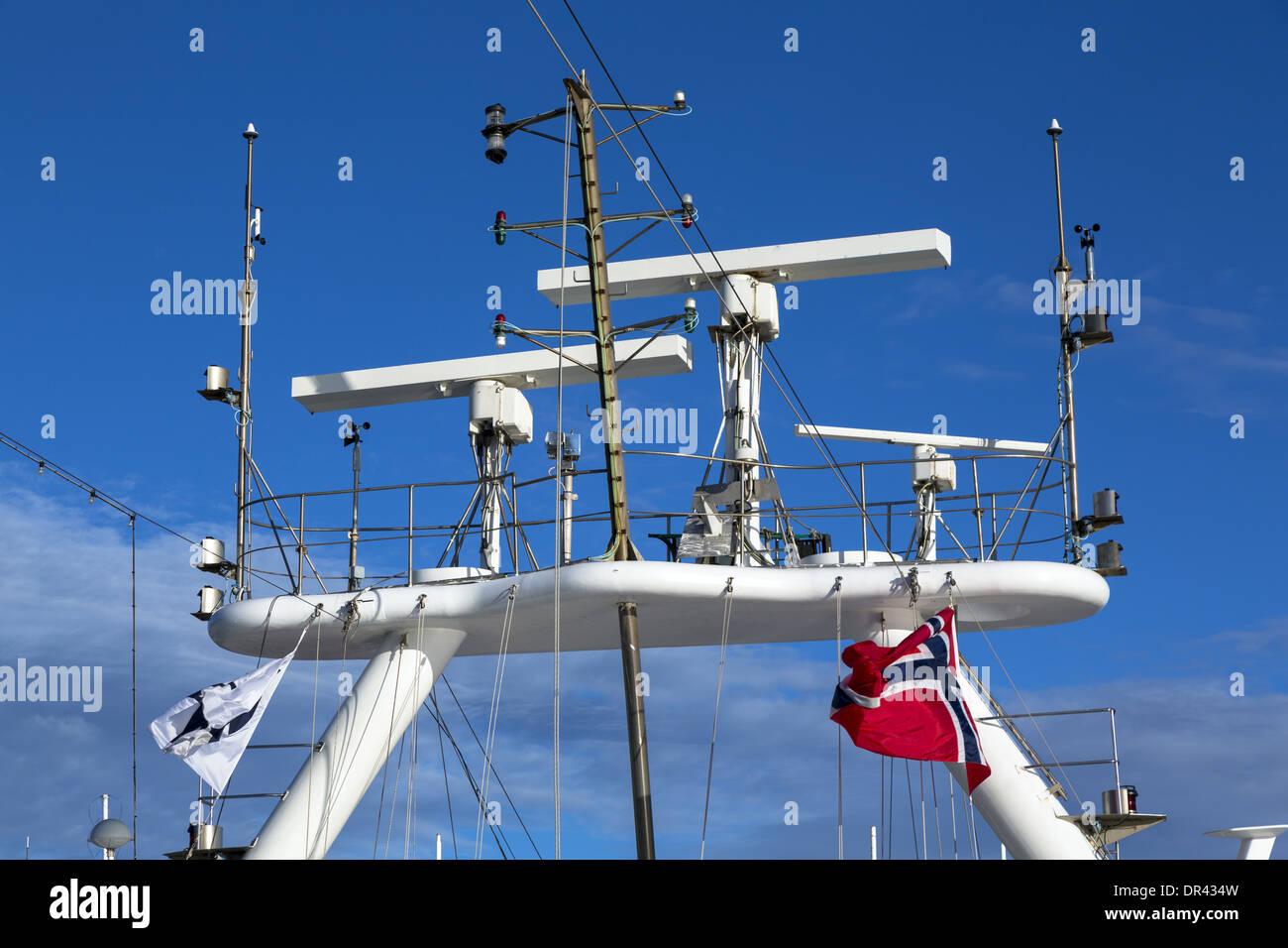 Navigation and radar equipment and antenna on a Radar Mast tower of a luxury cruise ship flying the flag of Norway Stock Photo