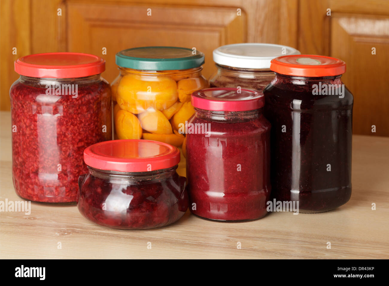 Various jams and compotes on table in kitchen Stock Photo