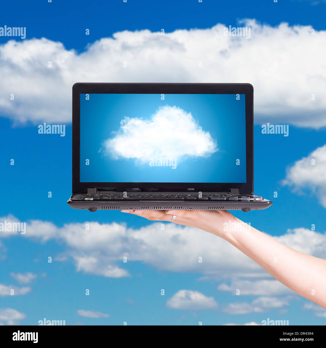 Picture of cloud from laptop screen under blue sky Stock Photo