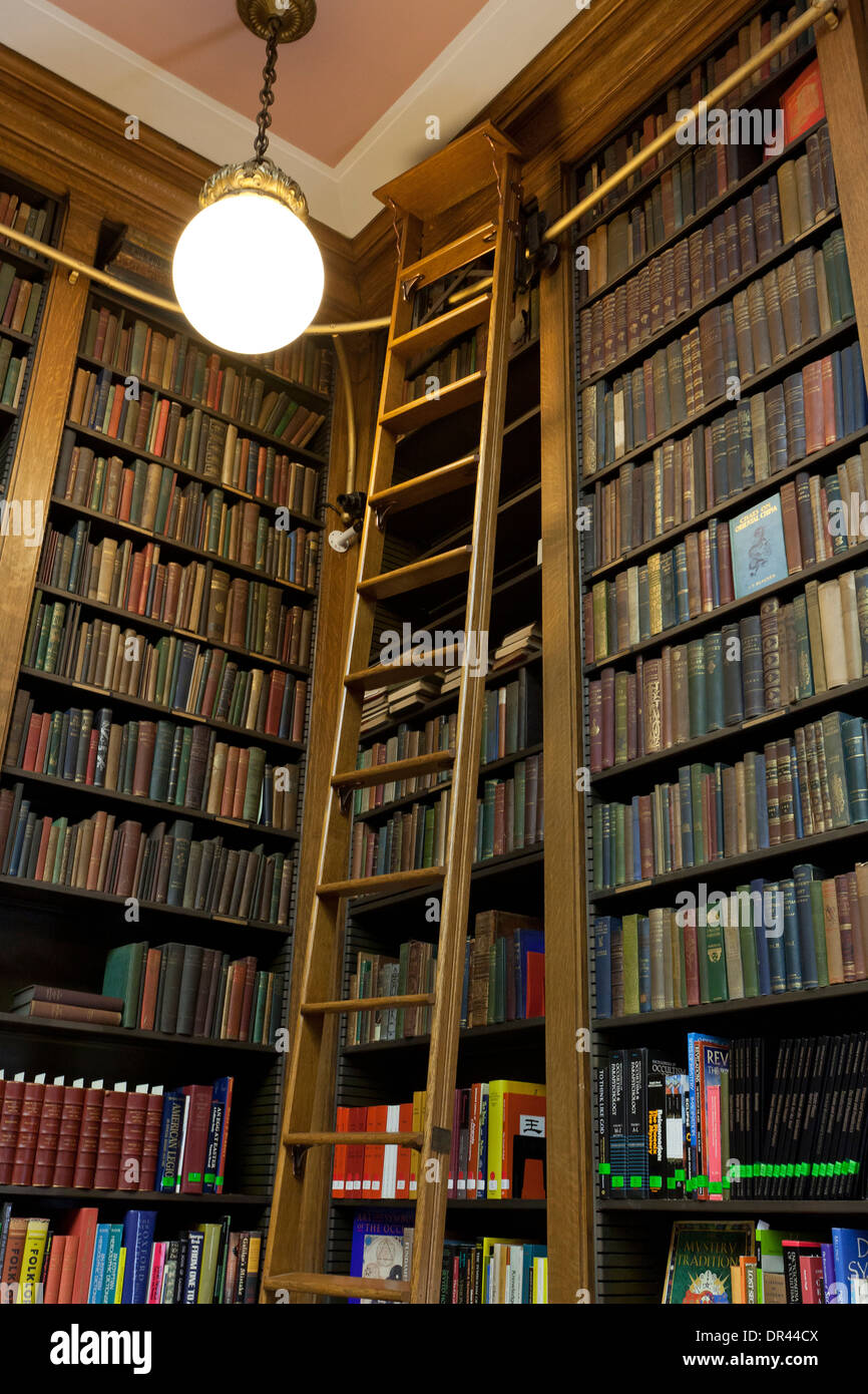 Shelves with antique books in library Stock Photo by ©feanaro