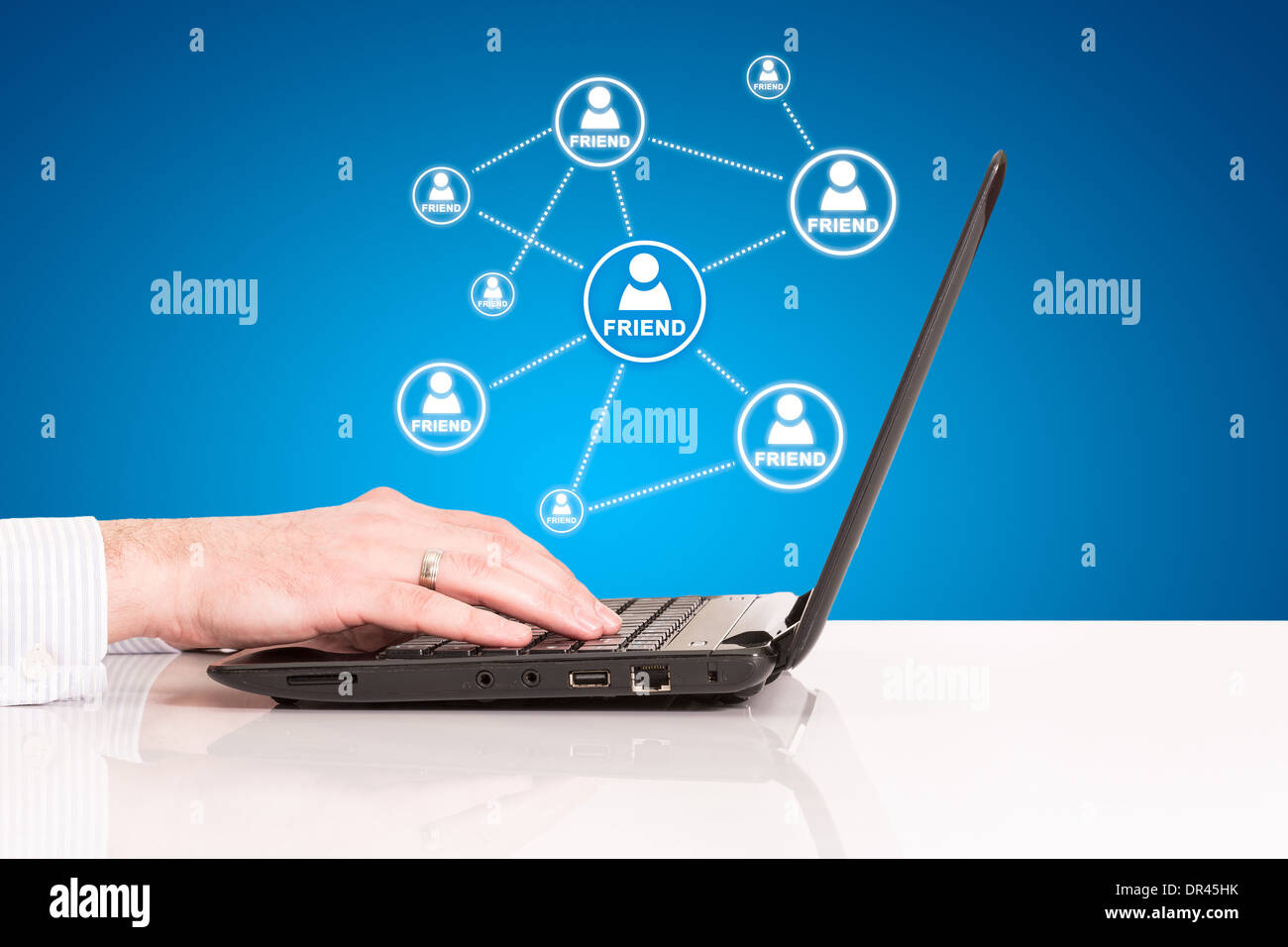 laptop business man hand touch pad, concept of technology social connection internet network on blue background Stock Photo