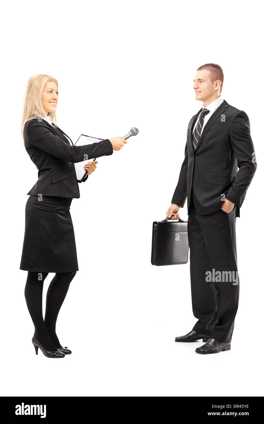 Full length portrait of a young female interviewer talking to male businessman Stock Photo