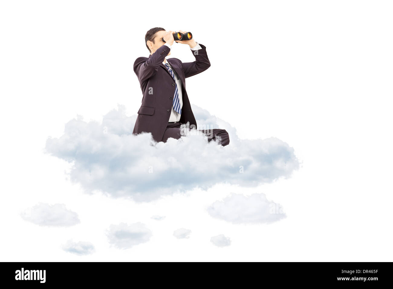 Young businessman looking through binoculars seated on cloud Stock Photo