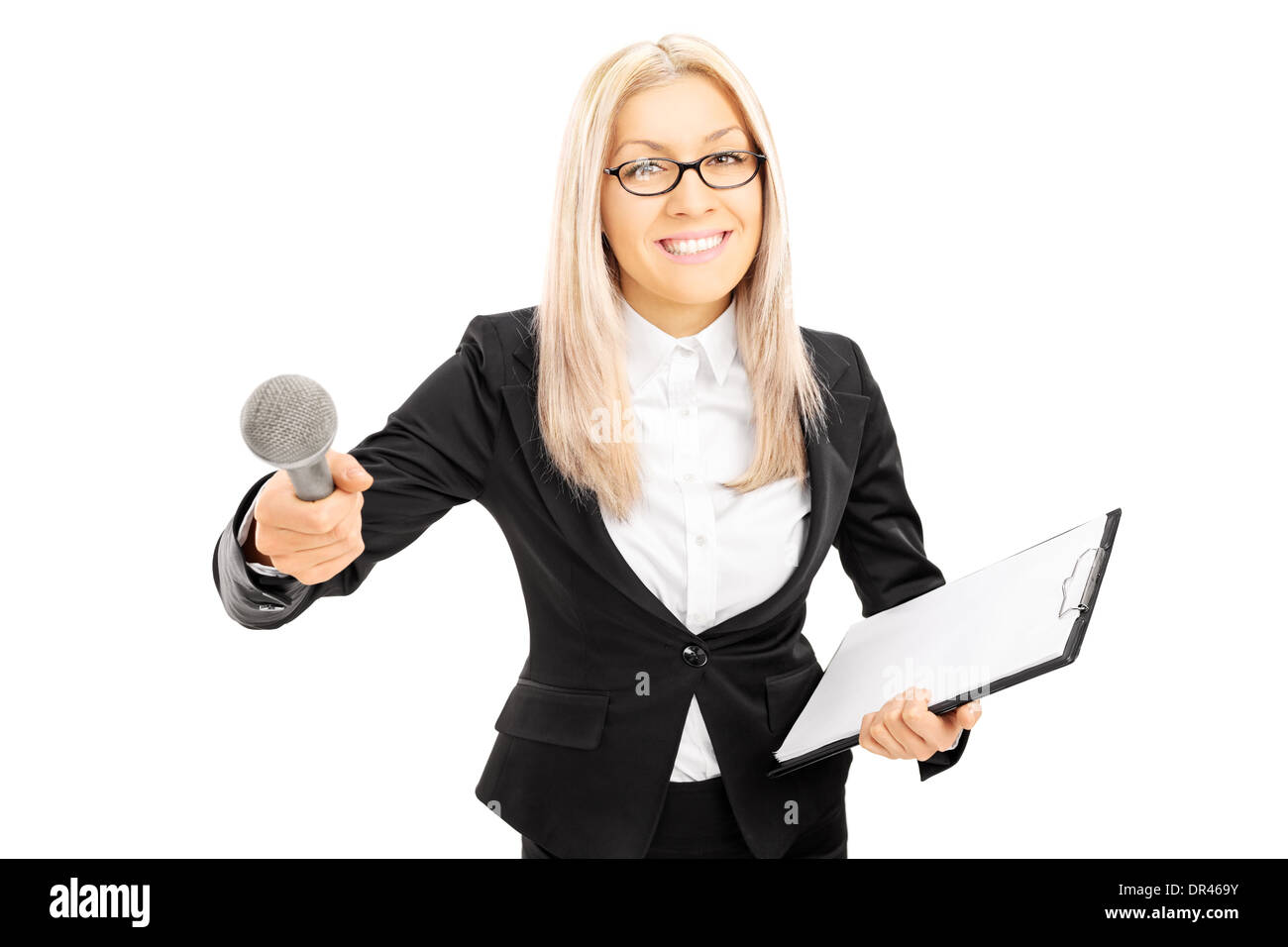 Young female interviewer holding clipboard and microphone Stock Photo