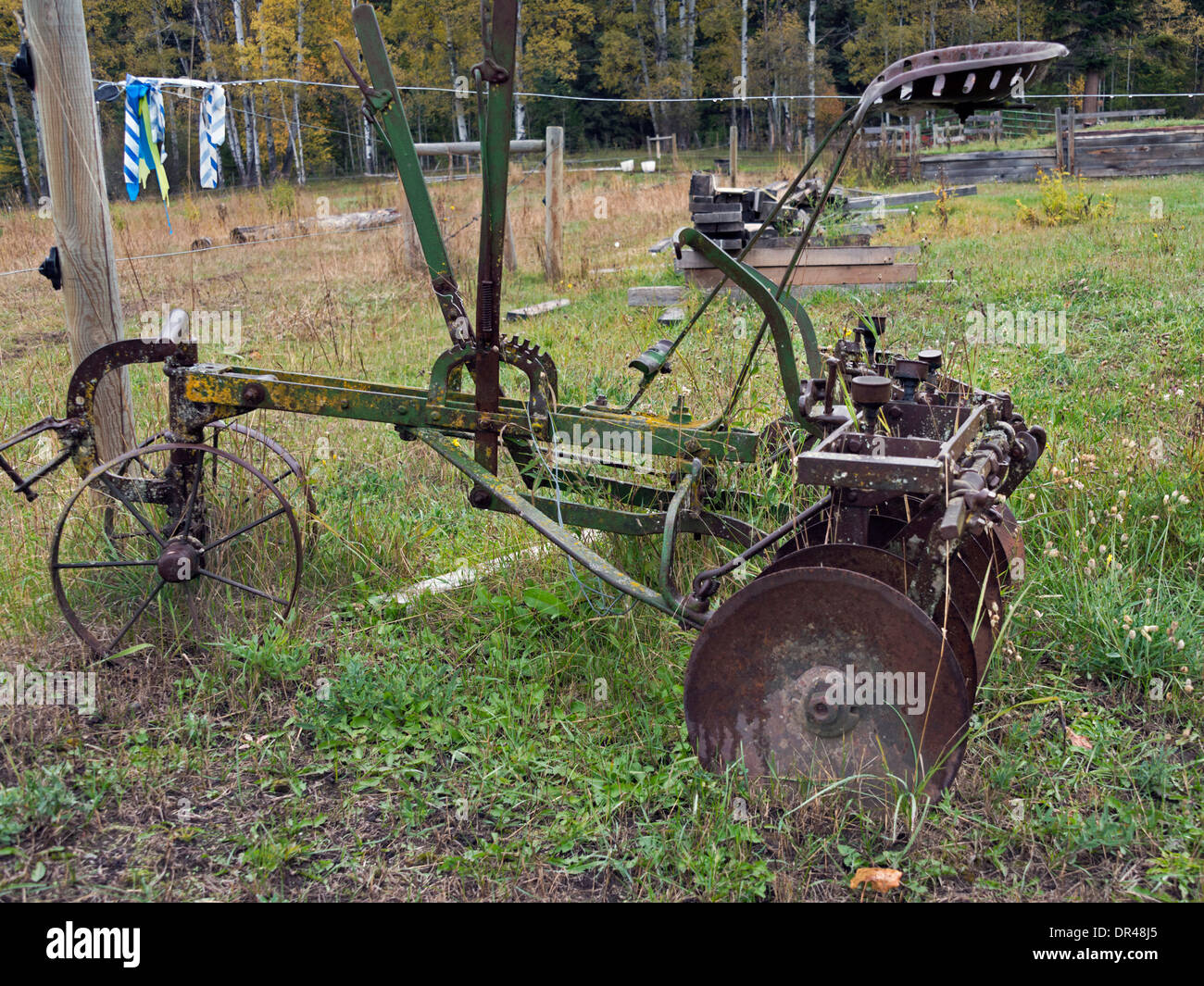 Side view of an antique 10 disk plow, on a farm near Likely, Cariboo-Chilcotin region, British Columbia Stock Photo