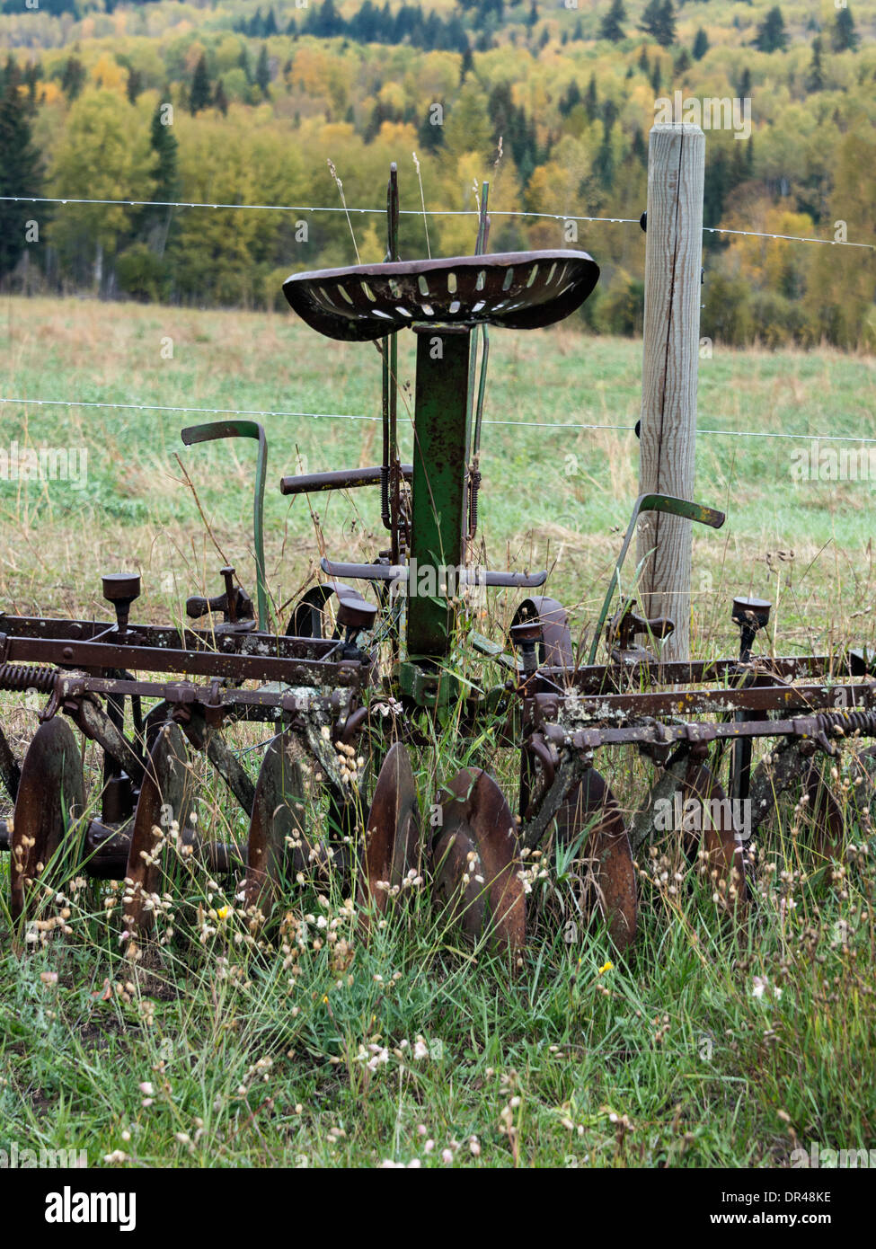 Antique 10 disk plow on a farm near Likely, Cariboo-Chilcotin region, British Columbia Stock Photo