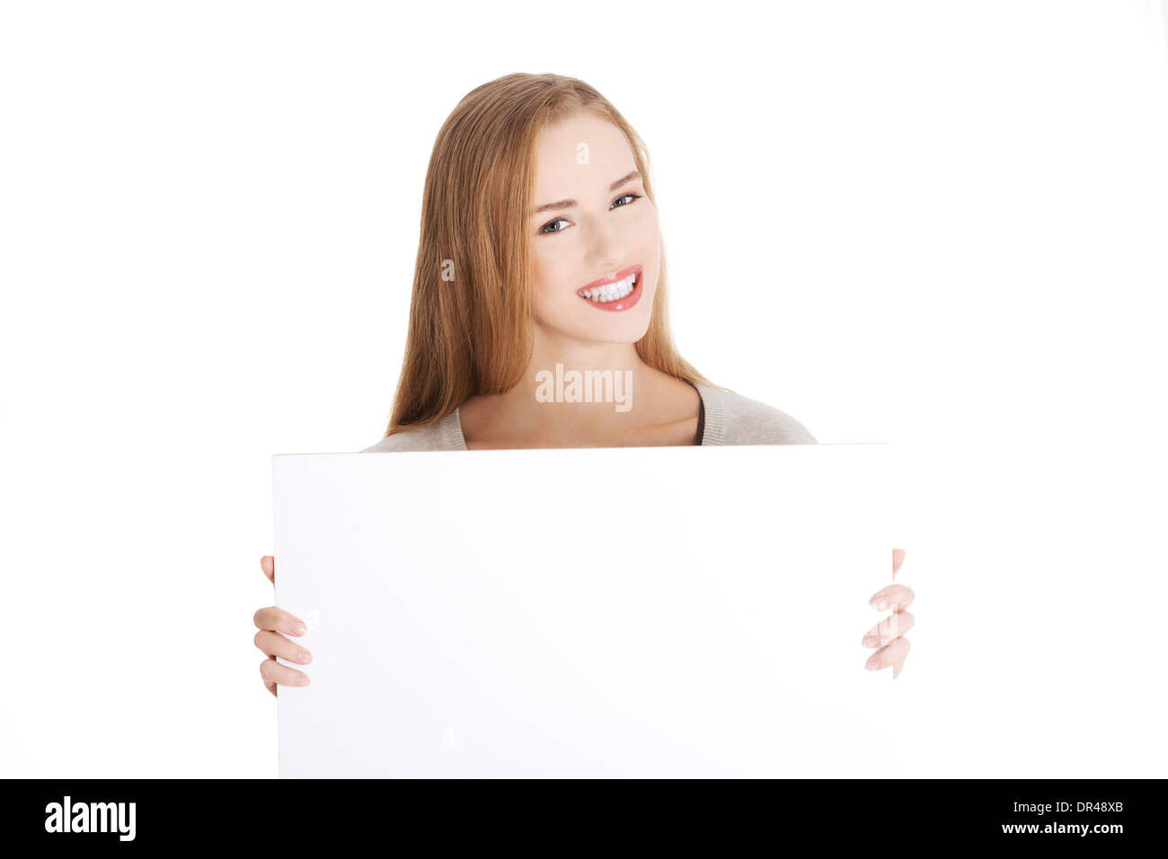 Beautiful casual woman holding copy space and advertising. Isolated on white. Stock Photo