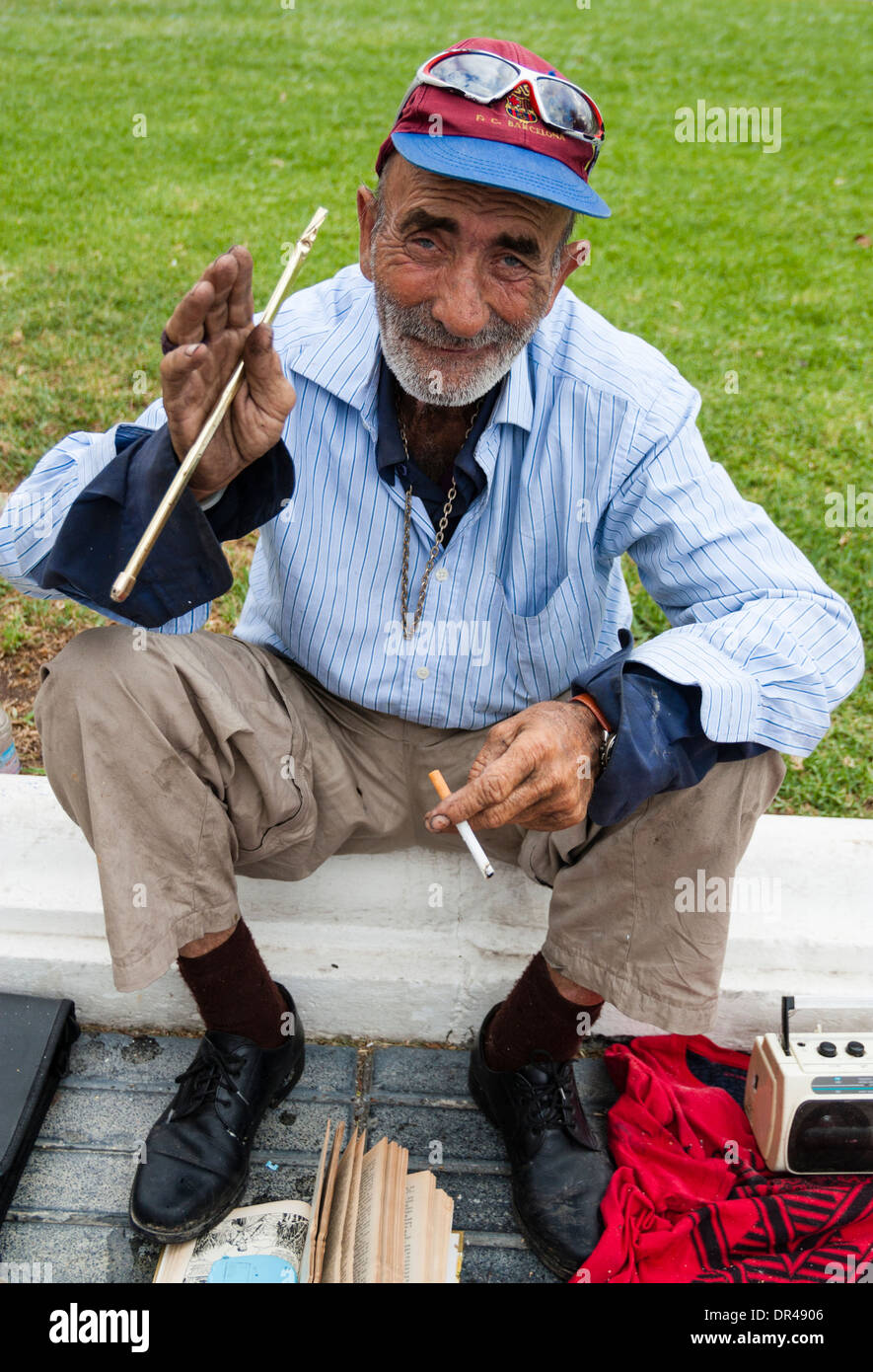 Elderly man selling odds and ends at Sunday market in Las Palmas, Gran Canaria Stock Photo