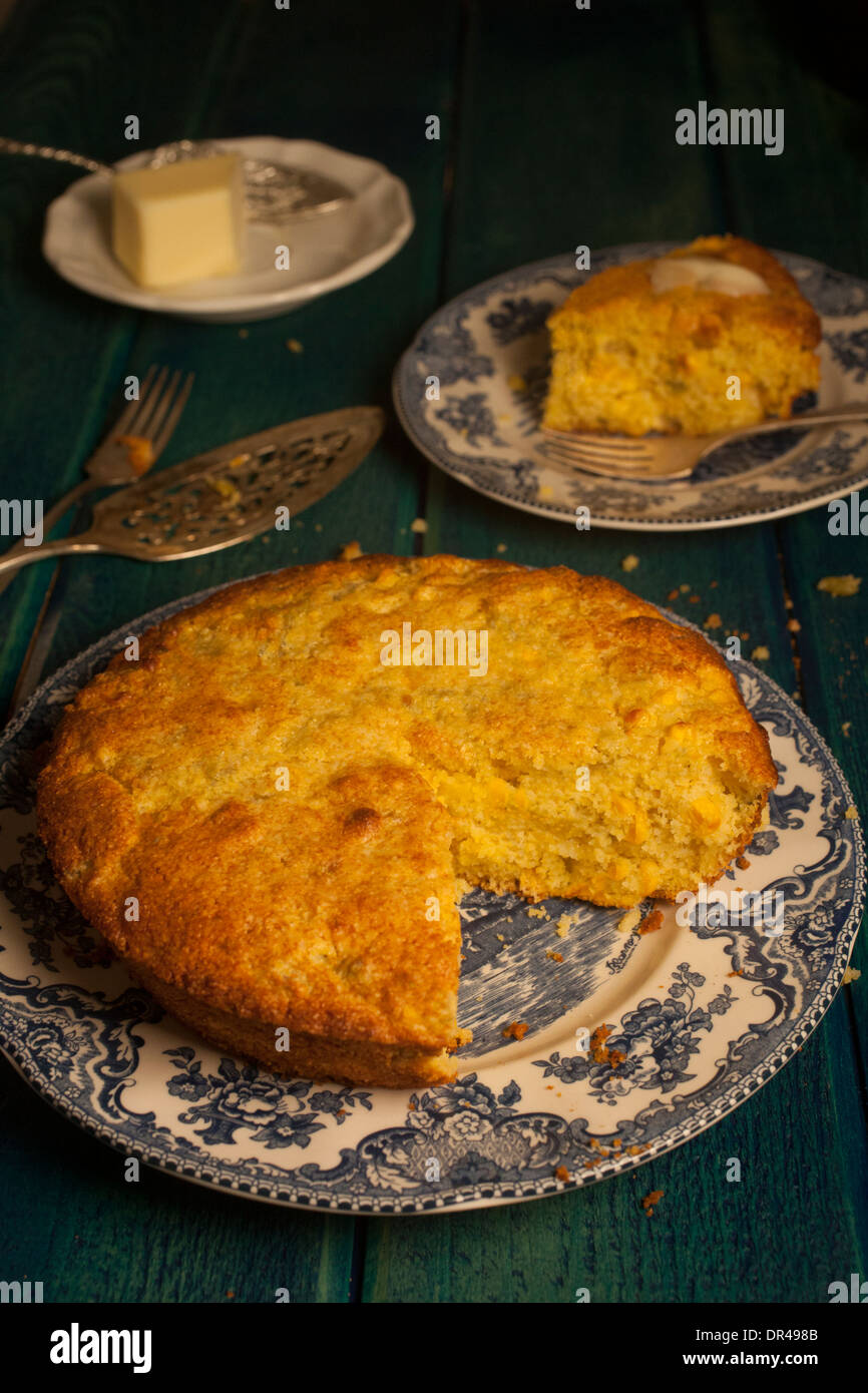 Round cornbread with slice taken out of it Stock Photo