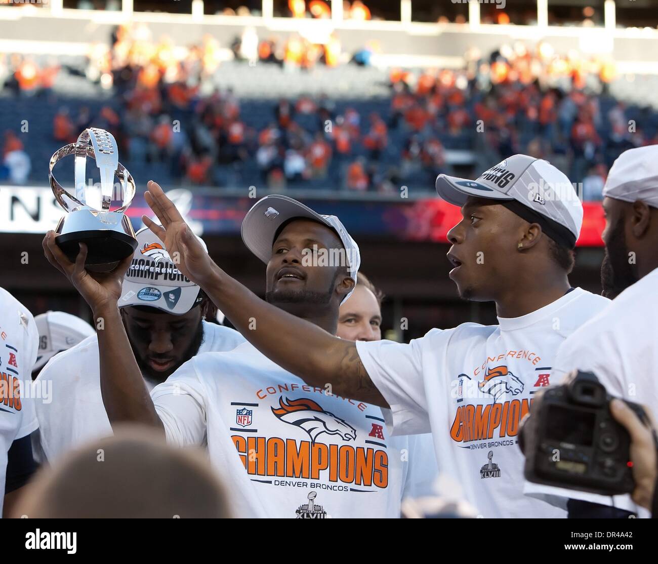 Denver, Colorado, USA. 19th Jan, 2014. Broncos CB CHAMP BAILEY, left, and team mates celebrate with the AFC Championship Trophy at Sports Authority Field at Mile High during the AFC Championship Game Sunday afternoon. The Broncos beat the Patriots 26-16. Credit:  Hector Acevedo/ZUMAPRESS.com/Alamy Live News Stock Photo
