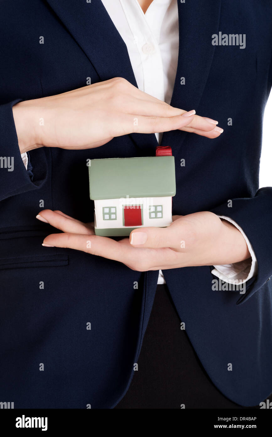 Close up on house modal in business woman's hands on belly. Stock Photo
