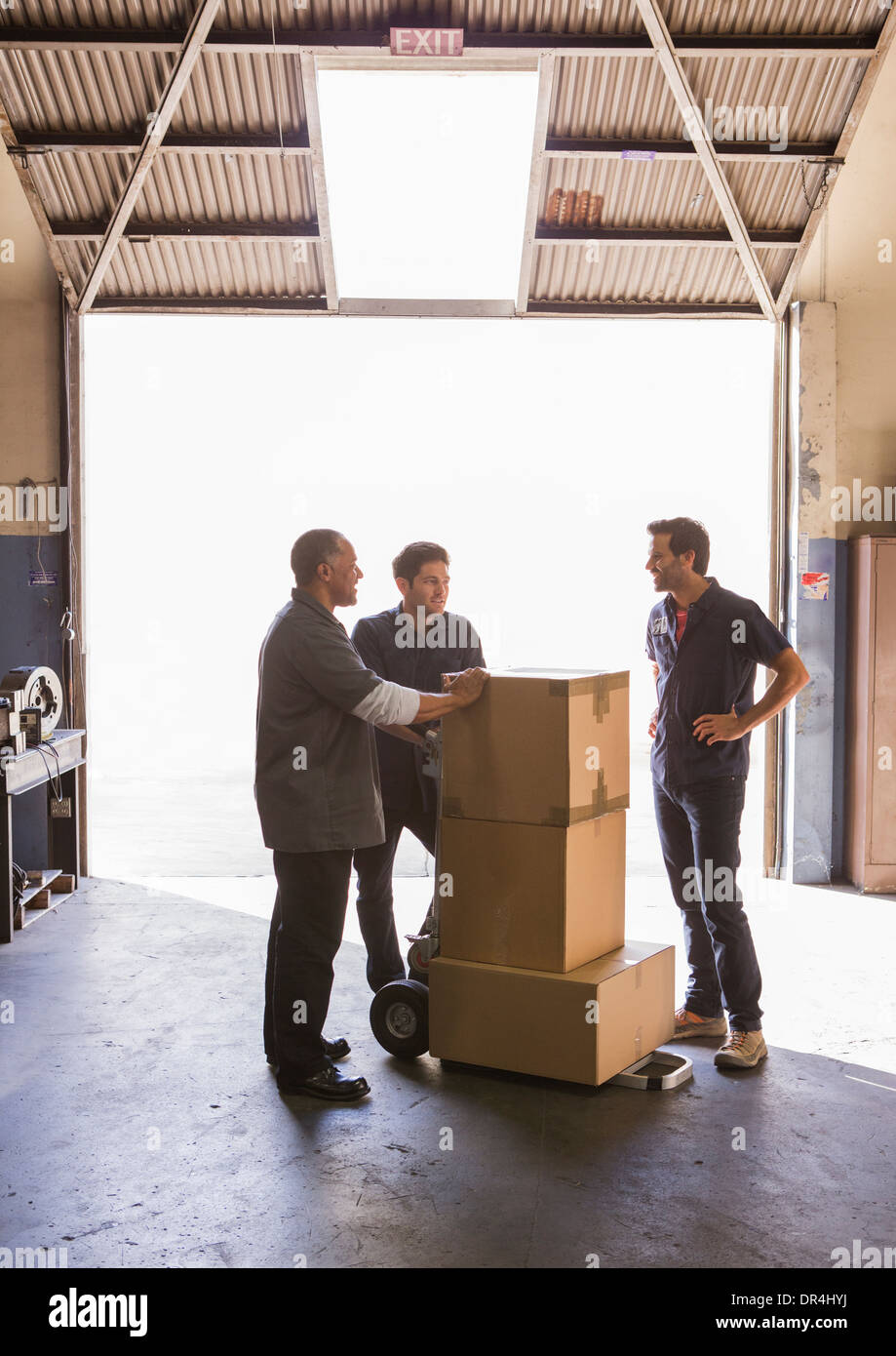 Workers talking in warehouse Stock Photo