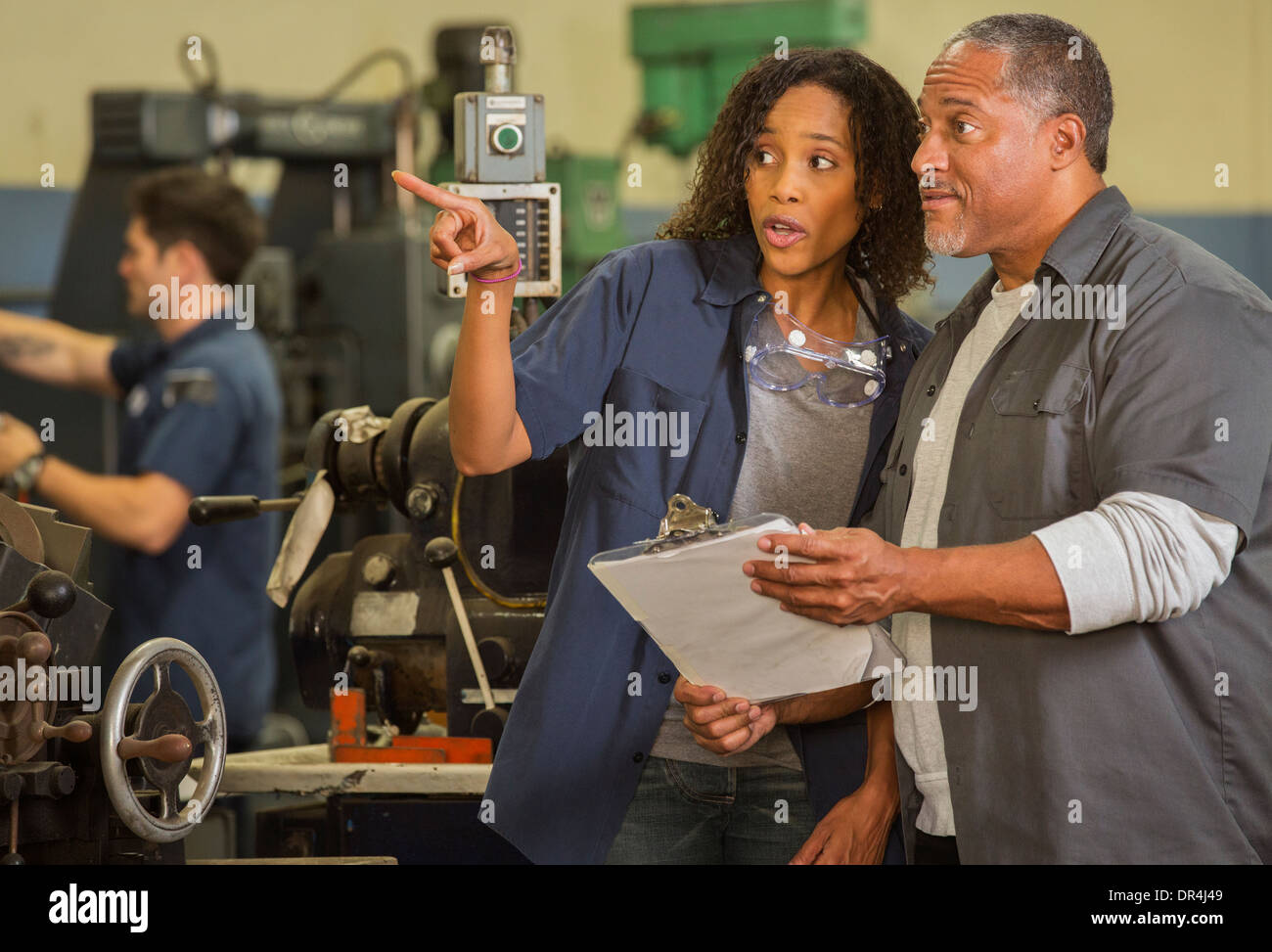 Workers talking in warehouse Stock Photo