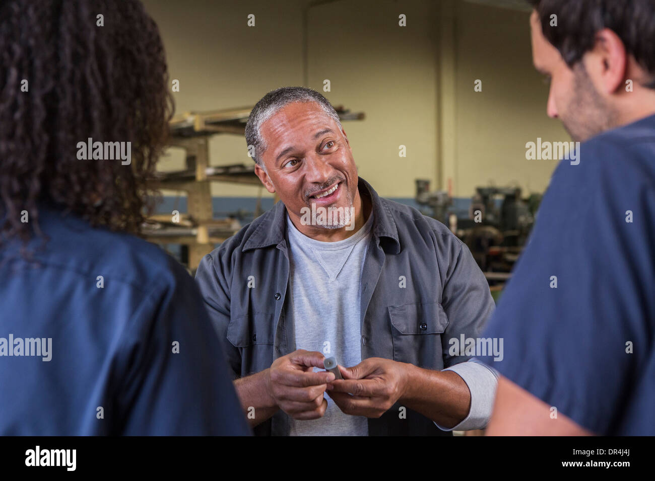 Workers talking in warehouse Stock Photo