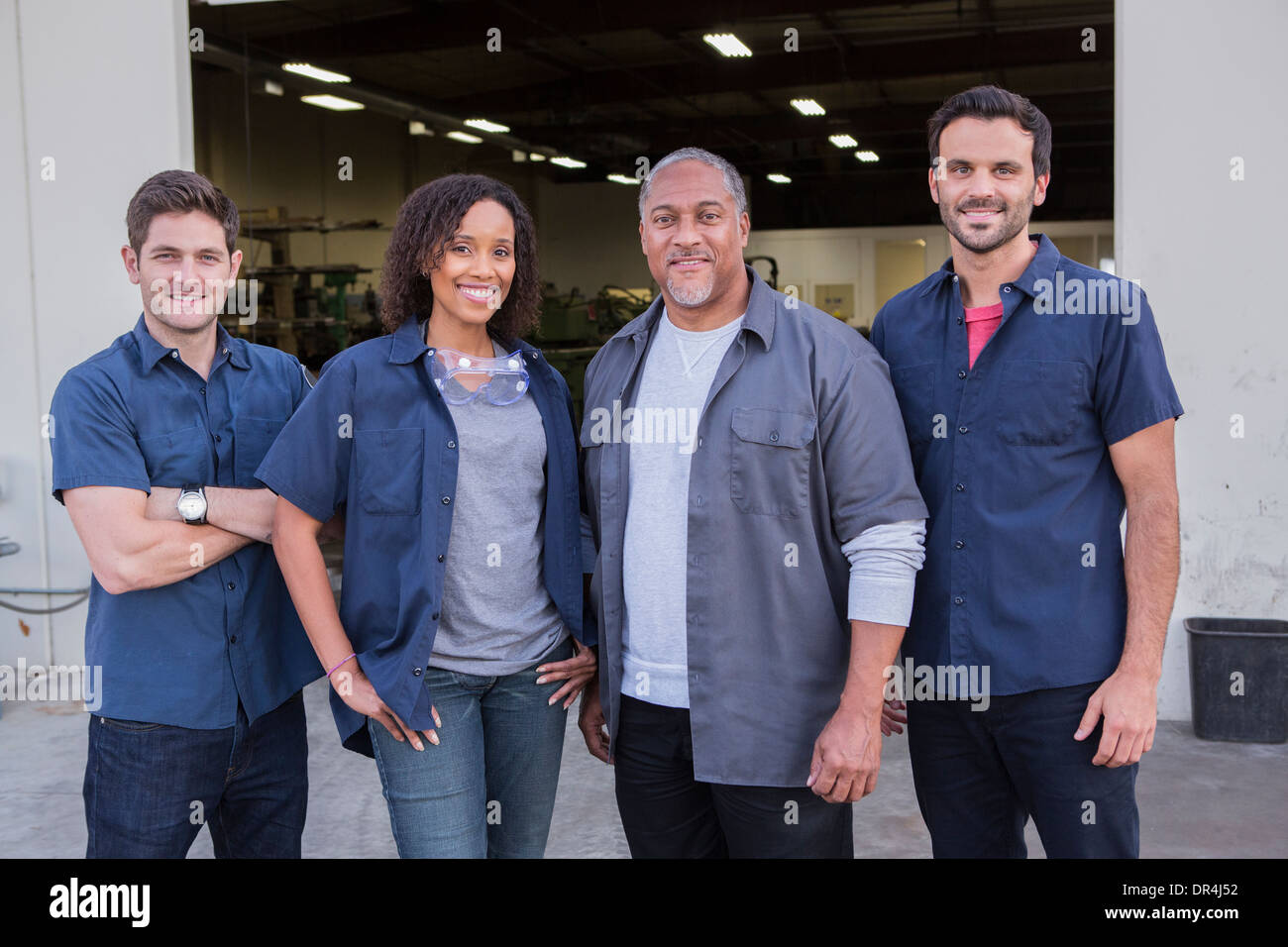 Workers smiling outside warehouse Stock Photo