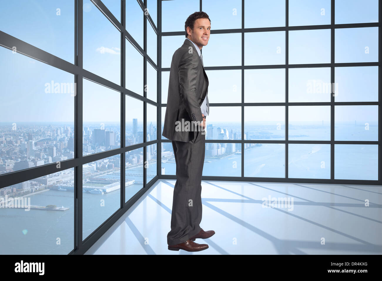 Composite image of smiling businessman with hand on hip Stock Photo