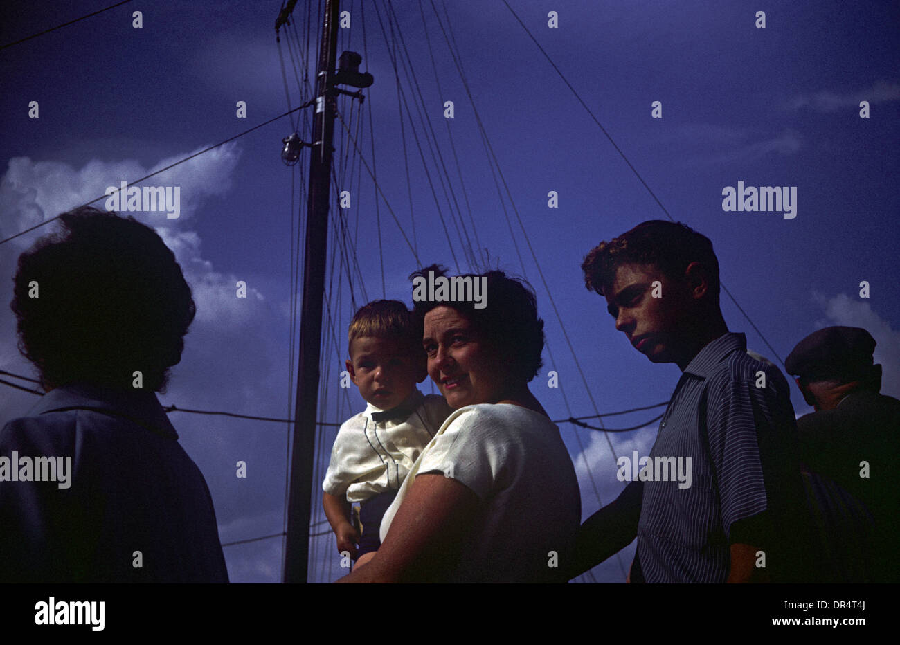 A mother holds her 3 year-old son during summer time in the early 1960s. Stock Photo