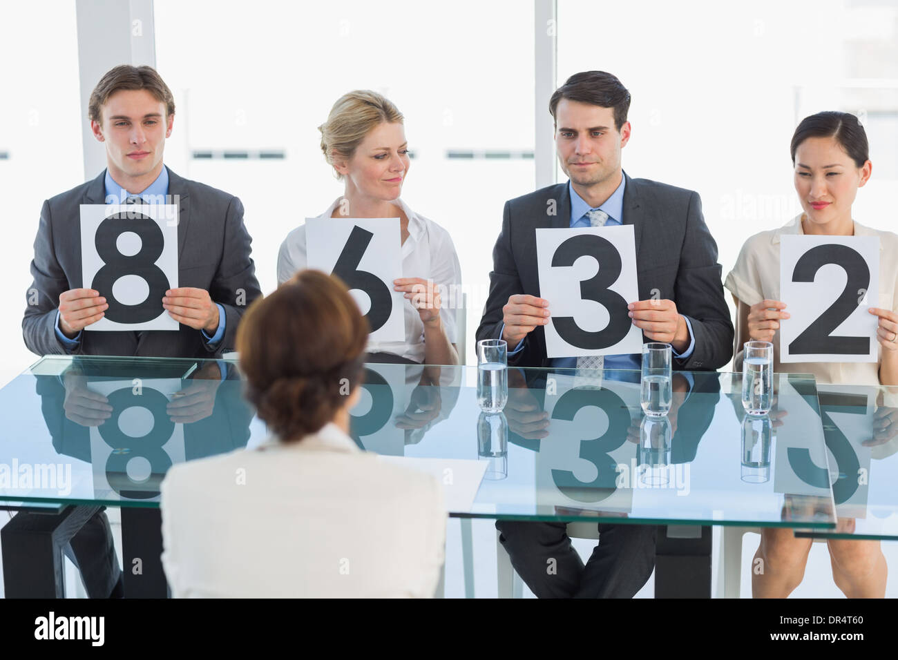 Judges in a row holding score signs Stock Photo