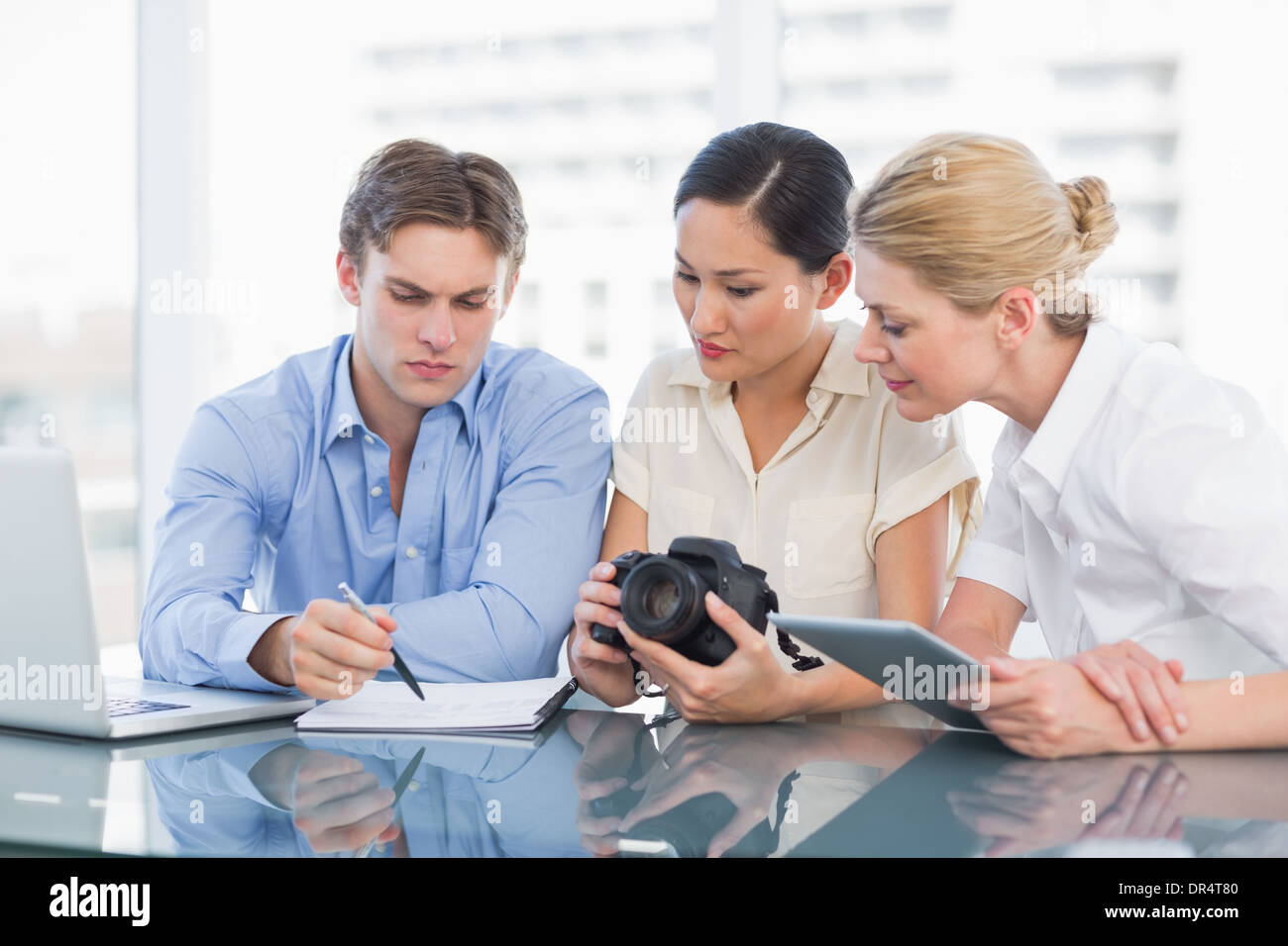 Colleagues working together at desk Stock Photo