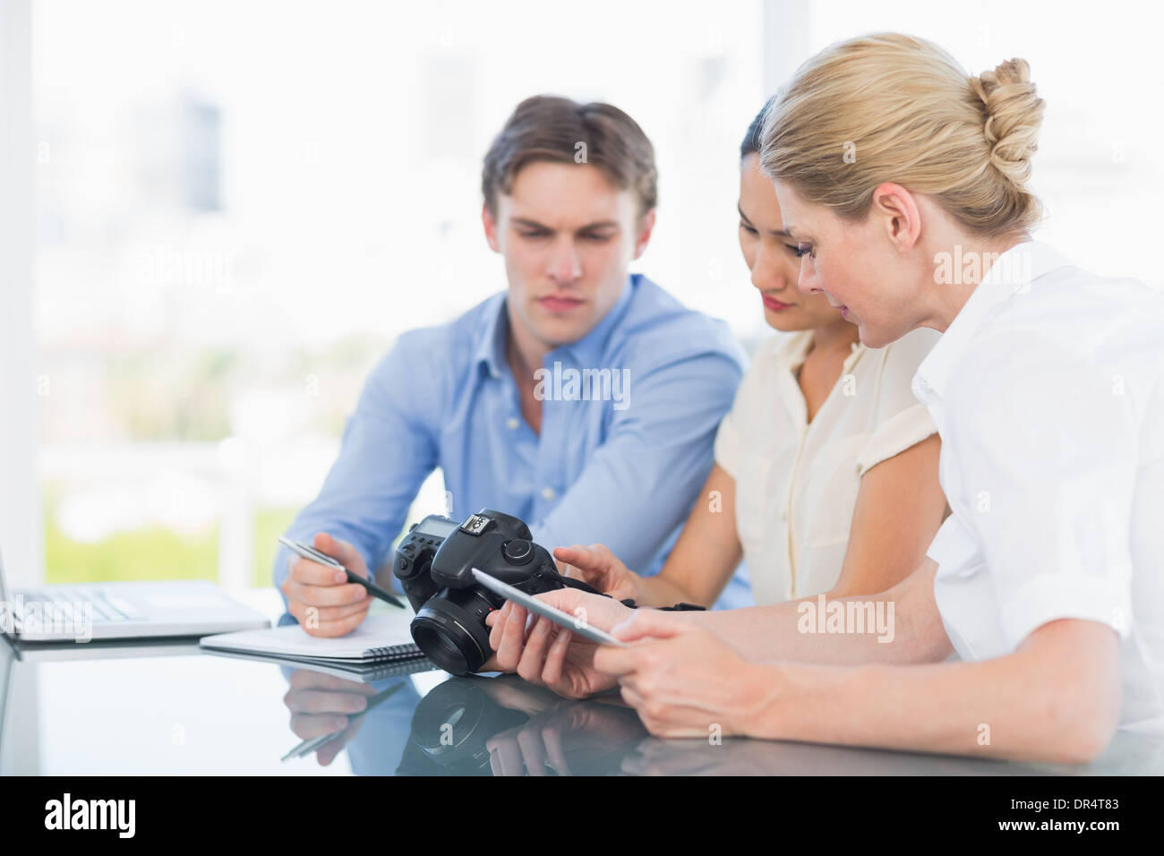 Colleagues working together at desk Stock Photo