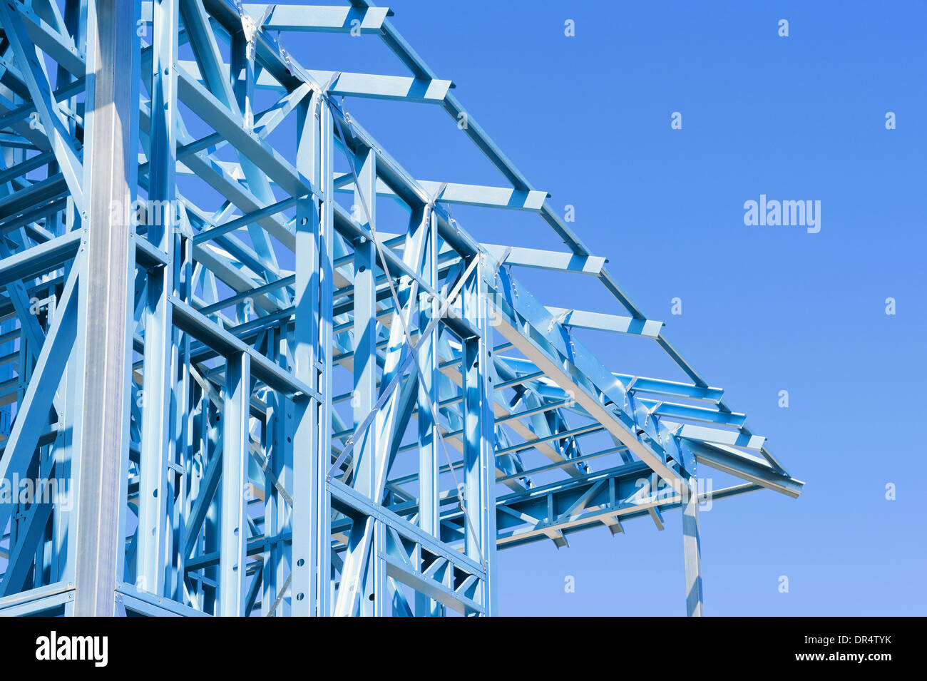 New residential construction home metal framing against a blue sky