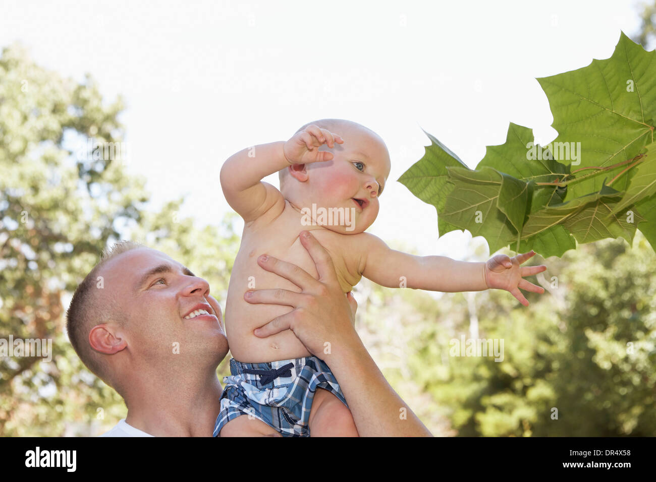 Father holding baby outdoors Stock Photo