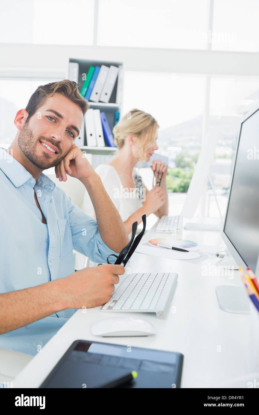 Smiling casual young couple working on computer Stock Photo