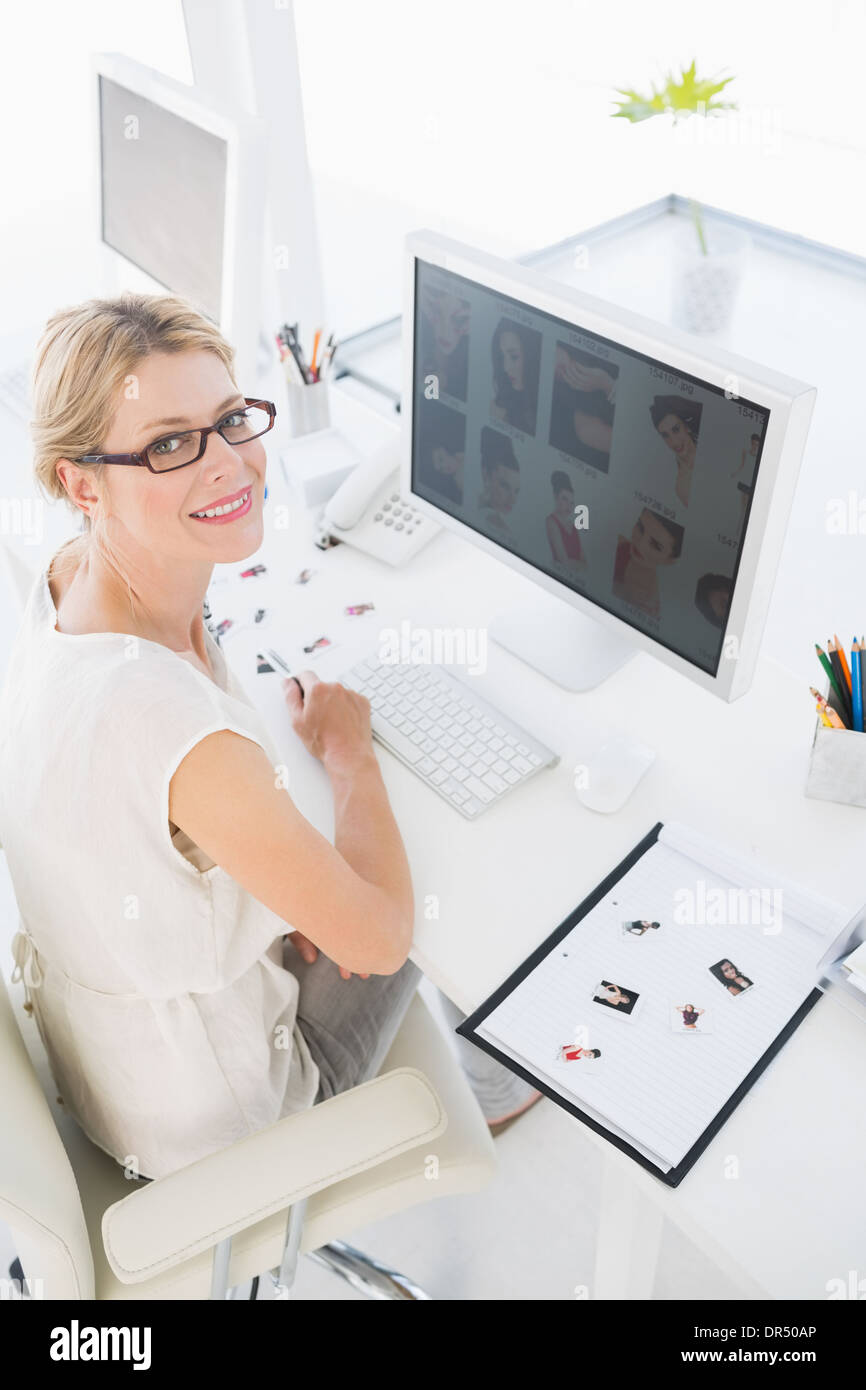 Female photo editor working on computer Stock Photo