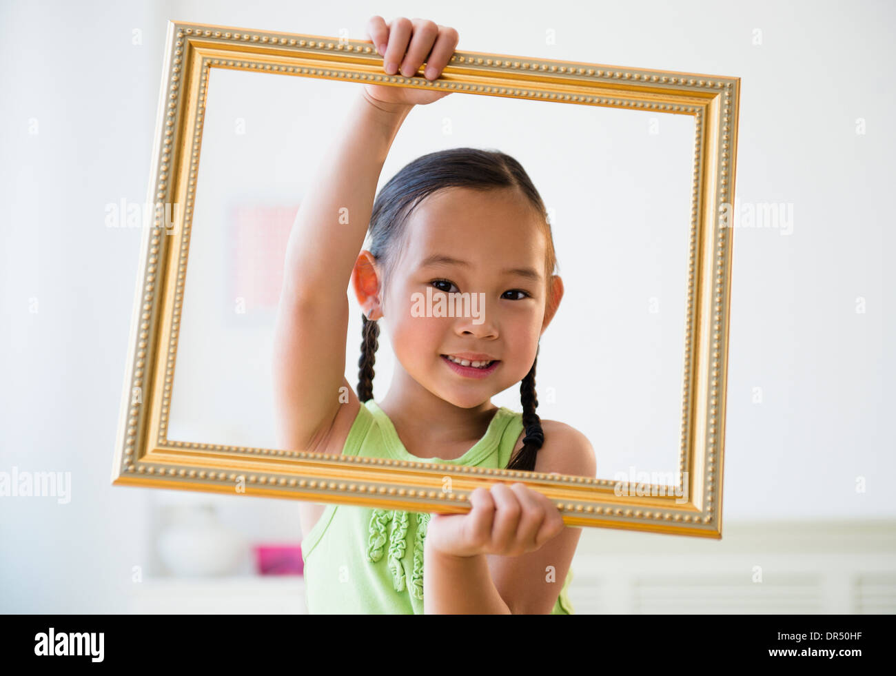 Korean girl holding empty picture frame Stock Photo