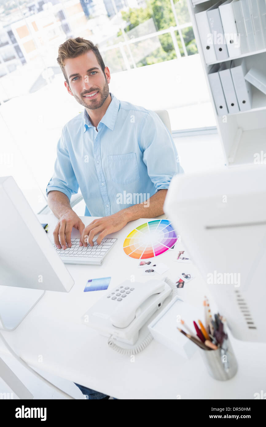 Smiling male photo editor using computer Stock Photo