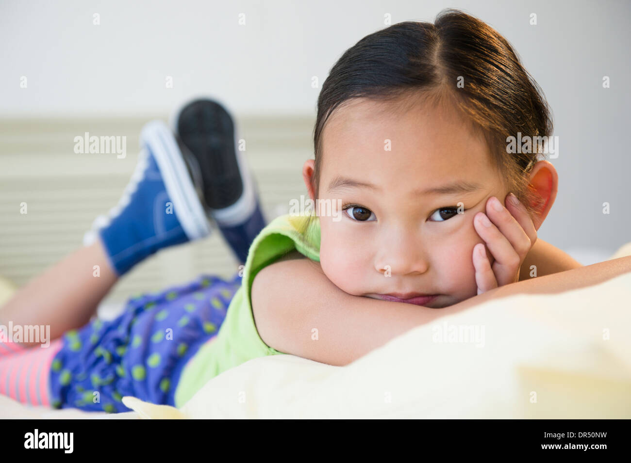 Korean girl laying on bed Stock Photo Alamy