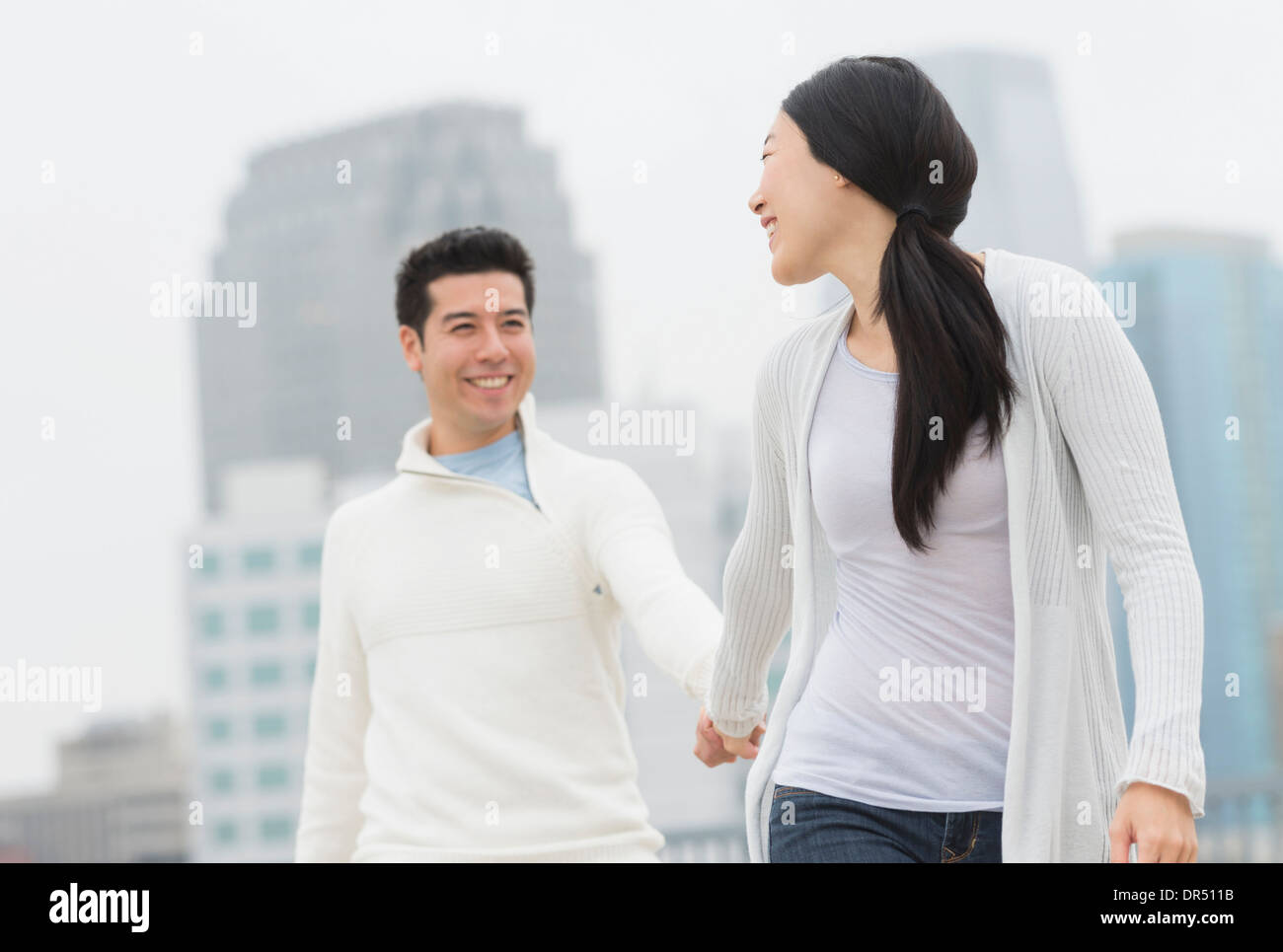 Couple holding hands in city Stock Photo