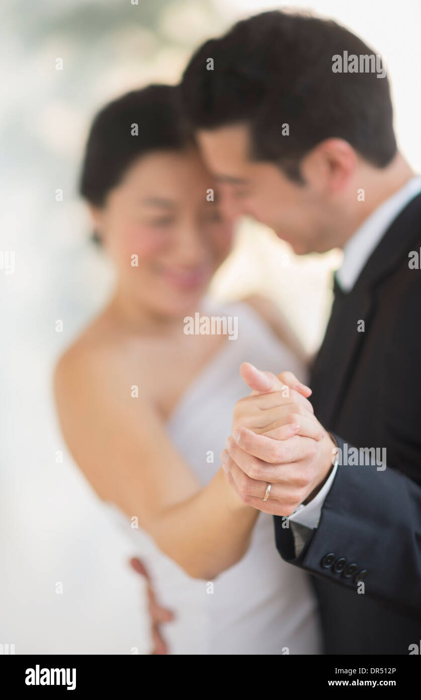 Newlywed couple dancing at wedding reception Stock Photo