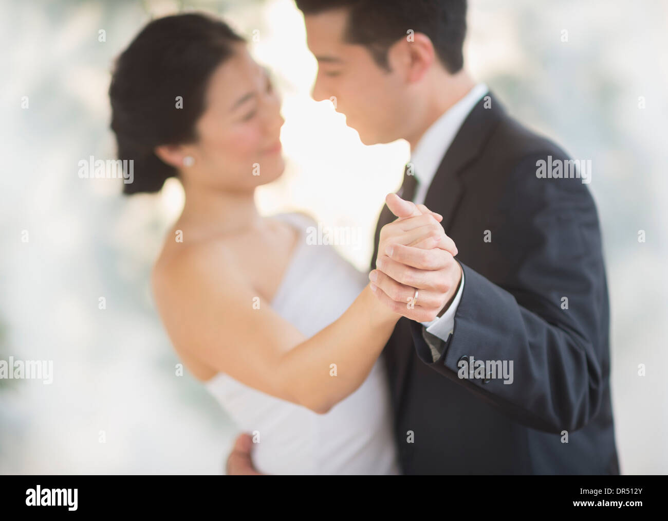 Newlywed couple dancing at wedding reception Stock Photo