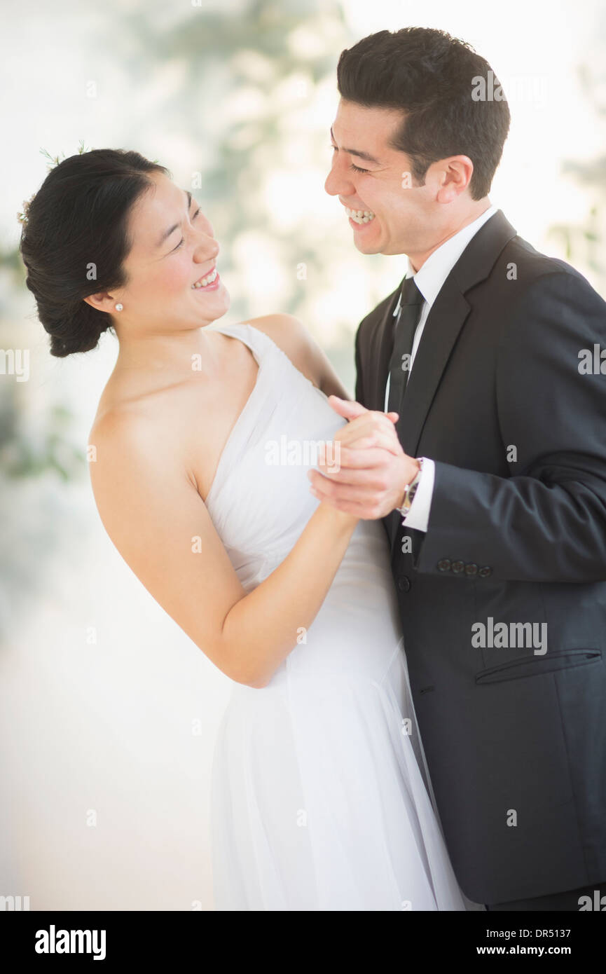 Newlywed couple dancing at wedding reception Stock Photo