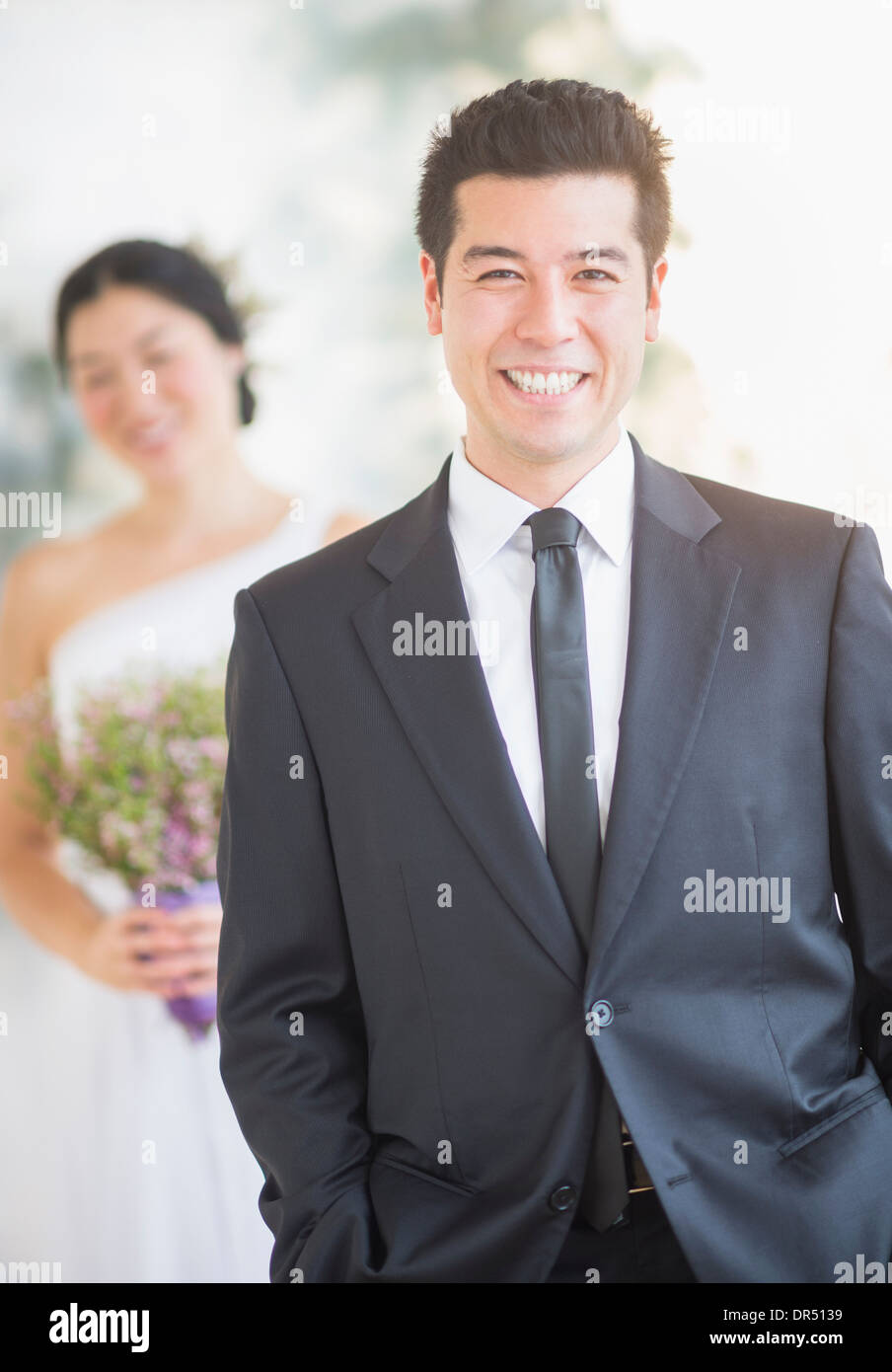 Newlywed groom smiling at wedding Stock Photo