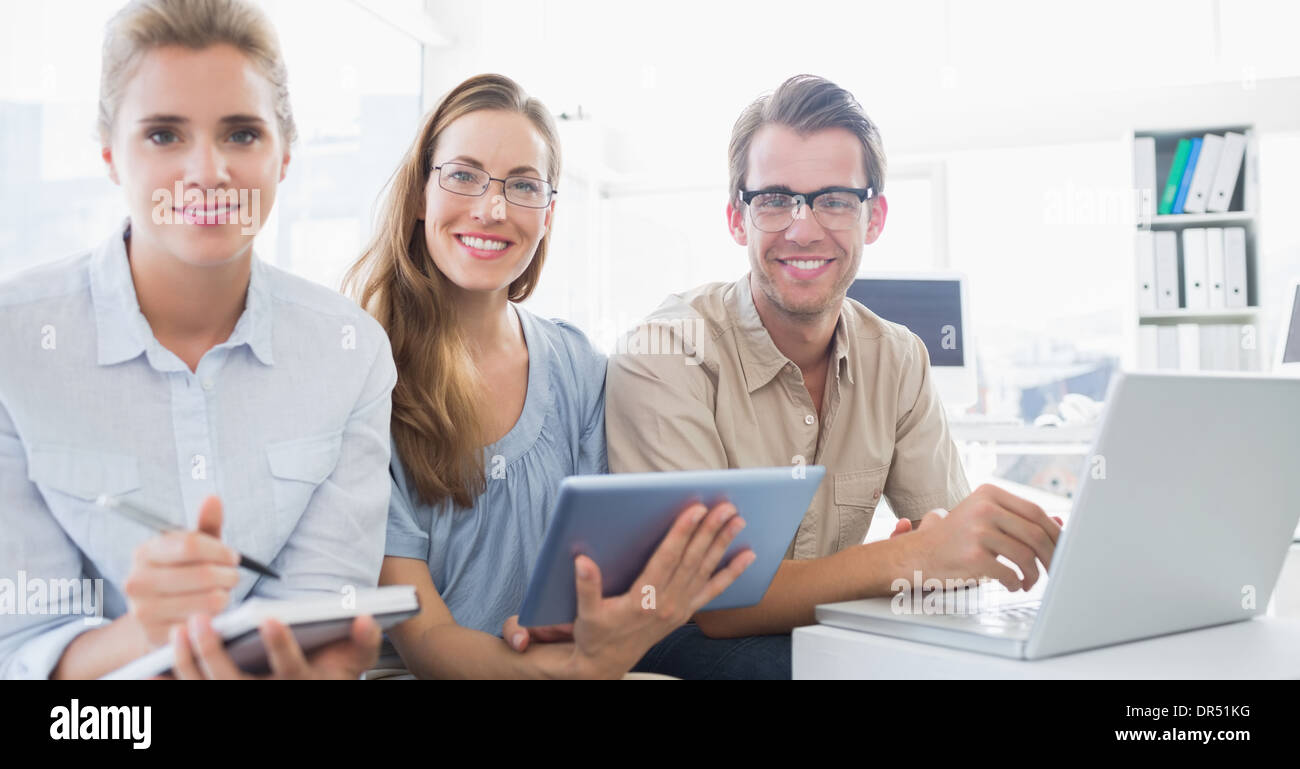 Portrait of three young people in office Stock Photo - Alamy