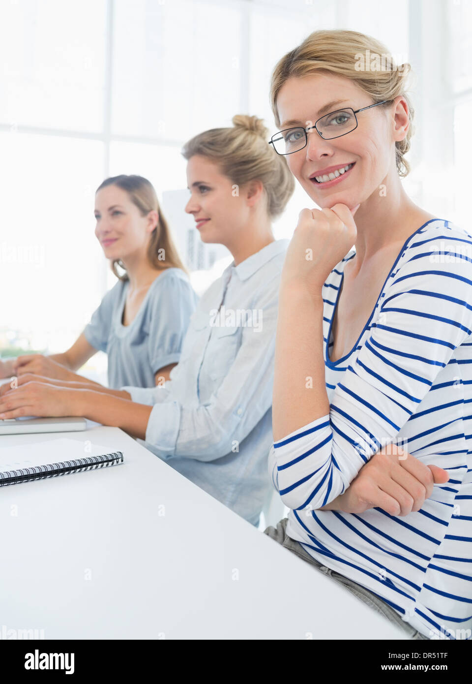 Three young people working in office Stock Photo - Alamy