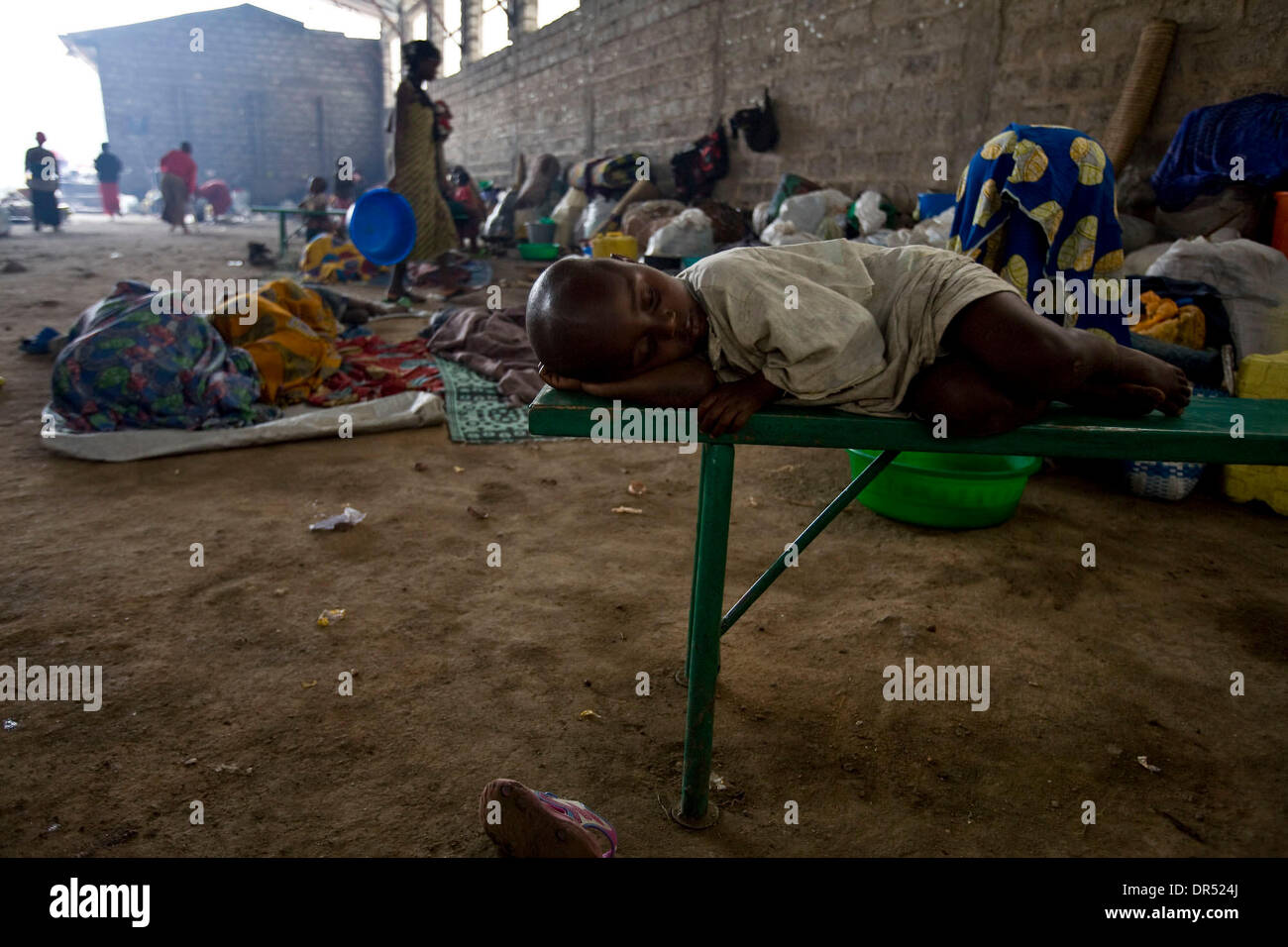 Dec 02, 2008 - Ngangi, Democratic Republic of Congo - A Congolese child sleeps on a bench in an IDP (internally displaced person) camp at the Don Bosco center in Ngangi, north of Goma. refugee (Credit Image: © T.J. Kirkpatrick/ZUMA Press) Stock Photo