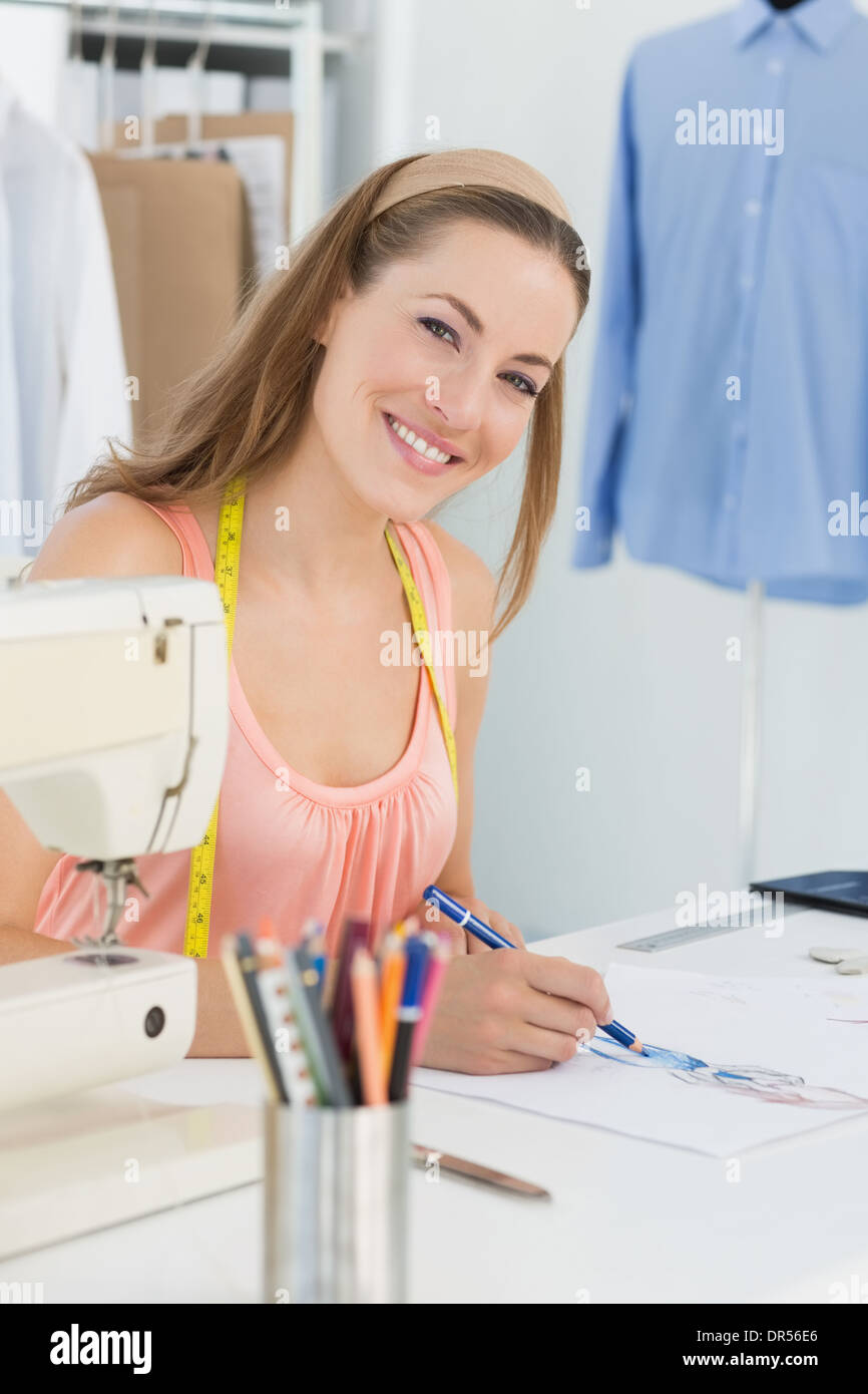 Smiling fashion designer working on her designs Stock Photo