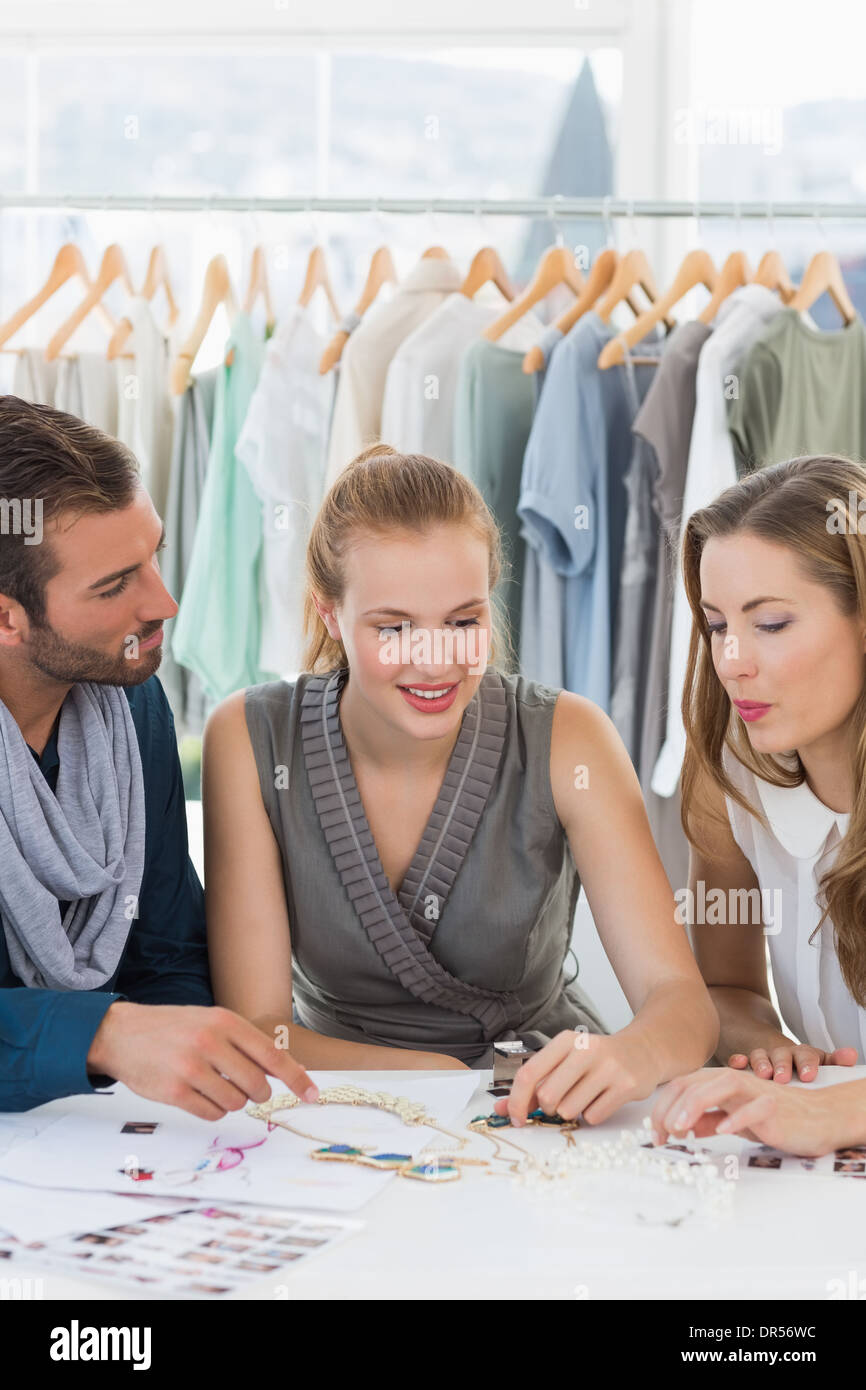 Three fashion designers discussing designs Stock Photo - Alamy