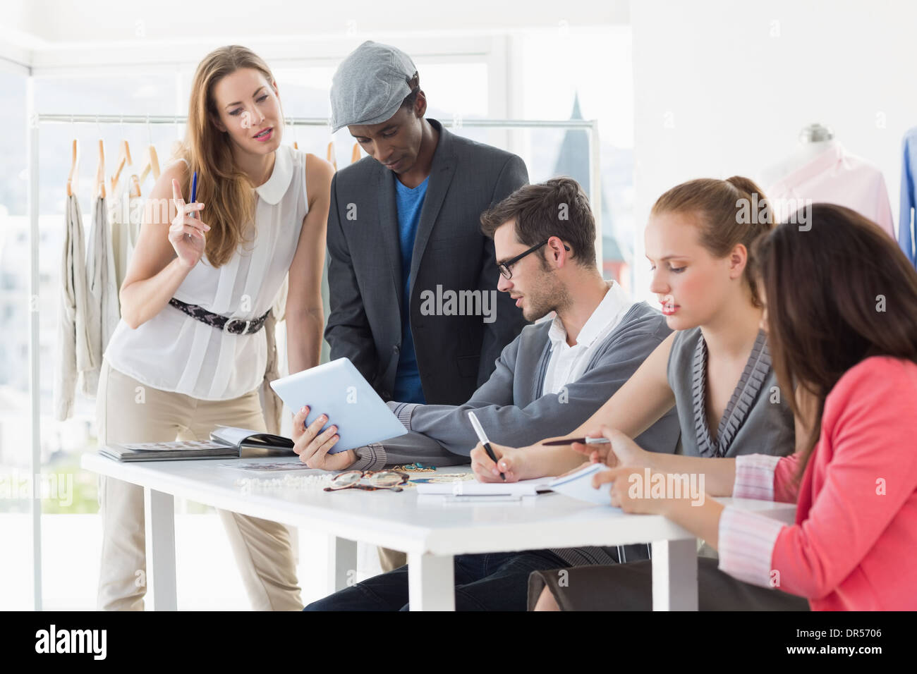 Fashion designers discussing designs Stock Photo - Alamy